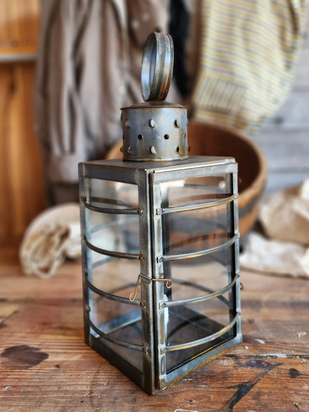 Square tin watch lantern with clear glass.