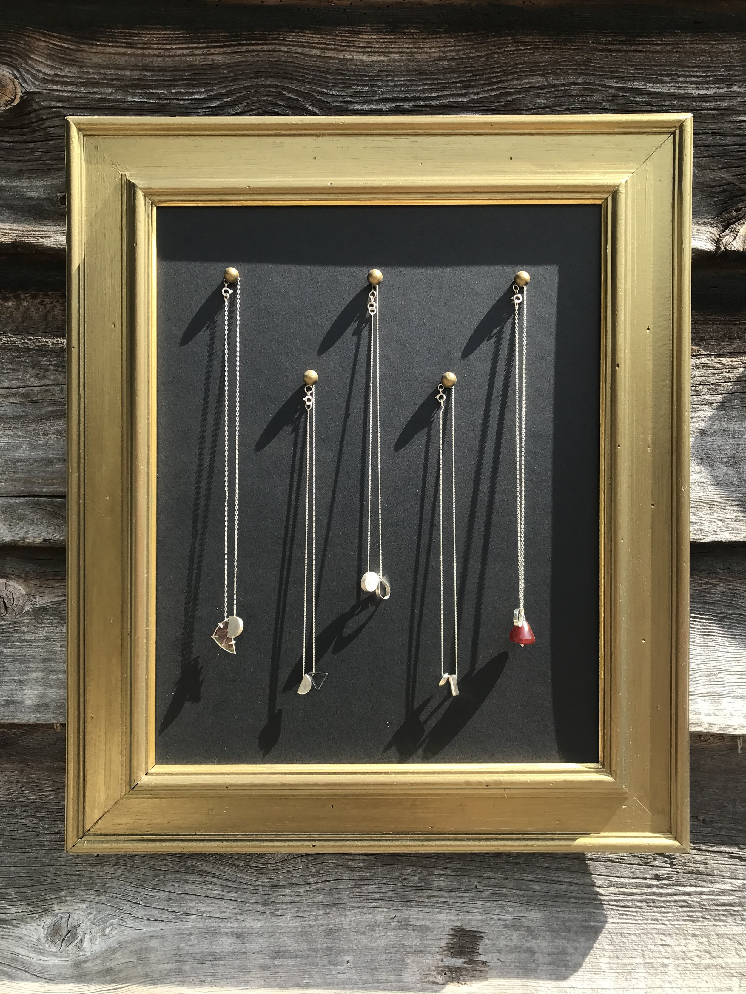 5 necklaces in picture frame.jpg