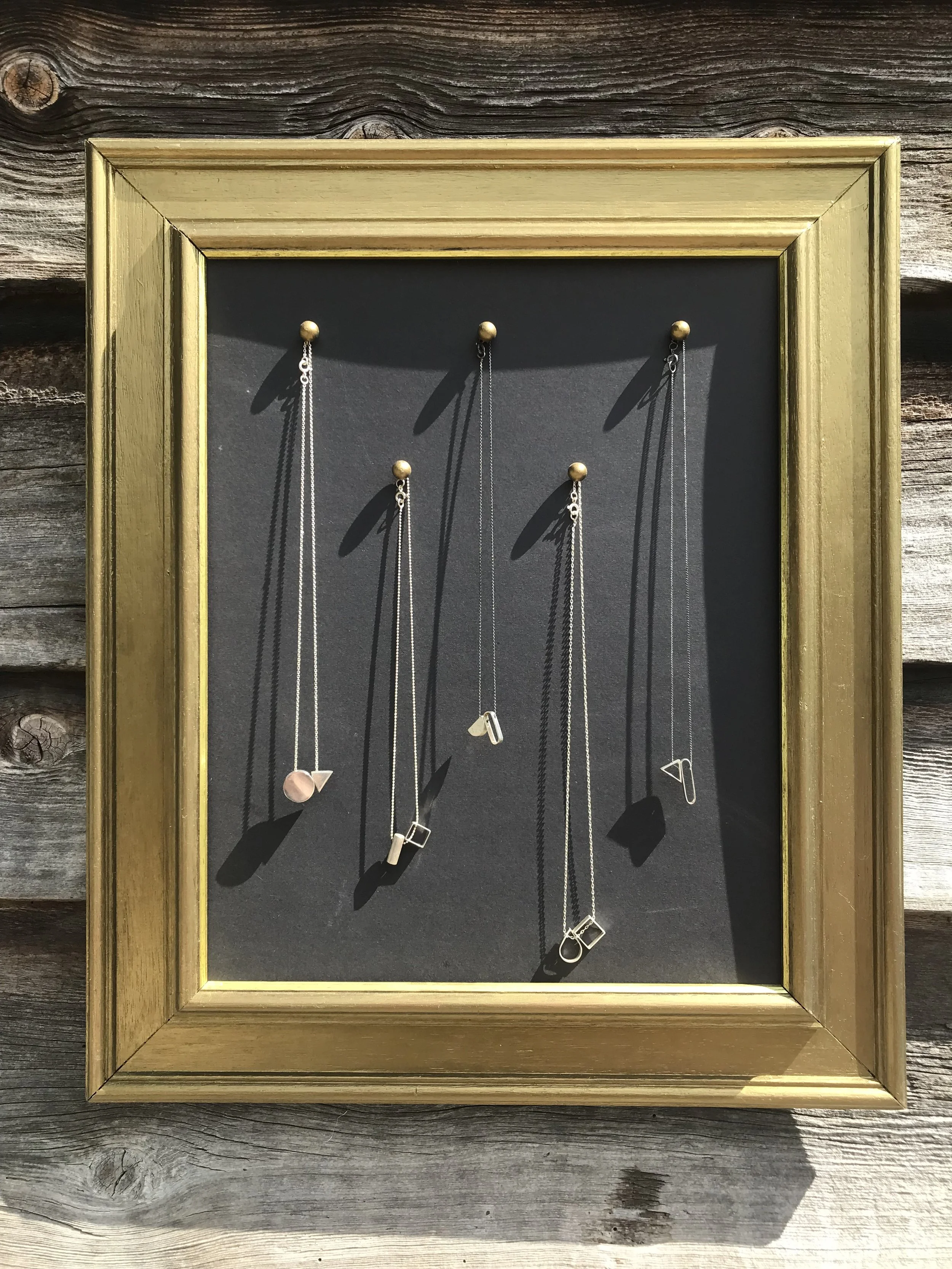 5 necklaces in picture frame 1.jpg