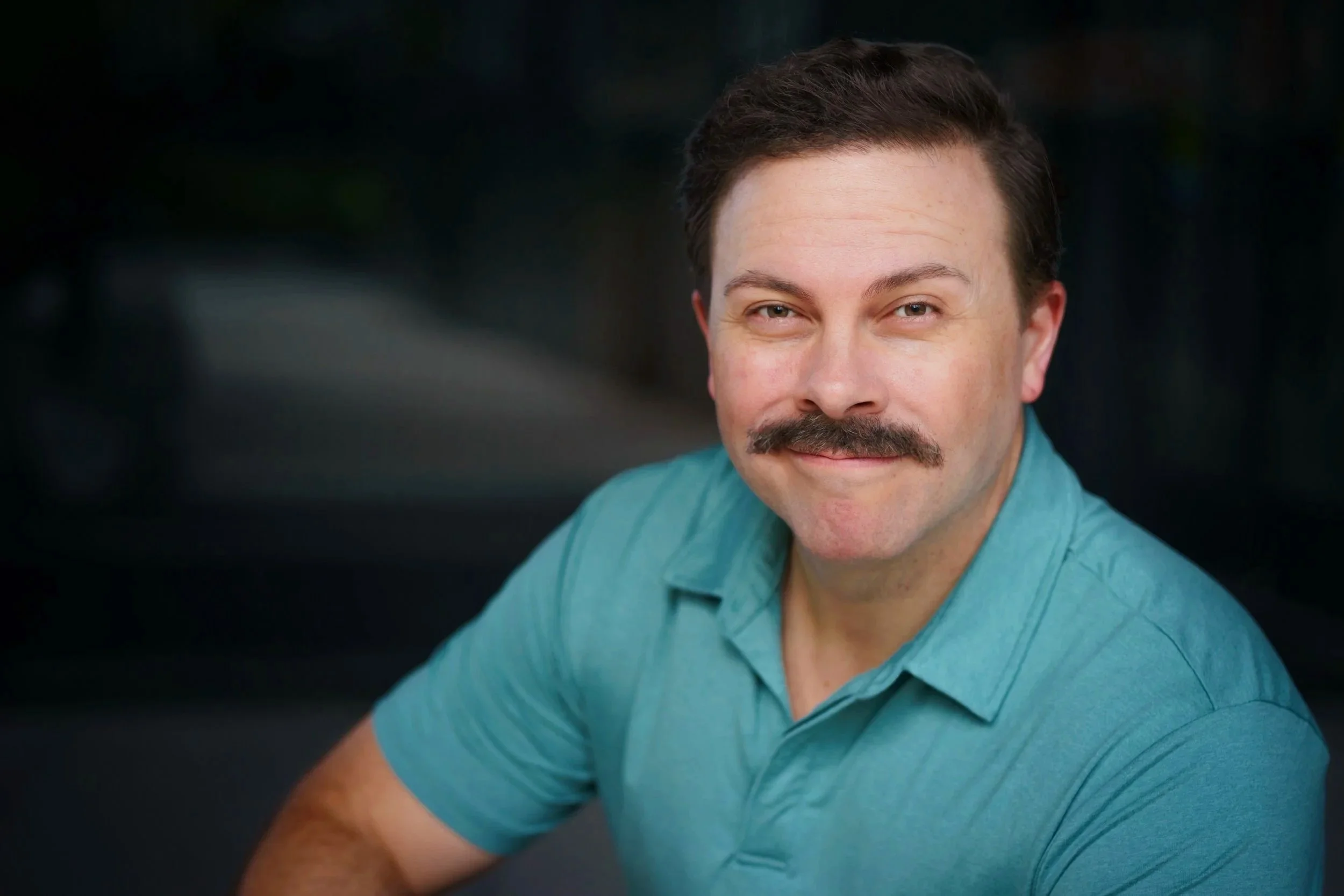 Matthew Cornwell headshot smiling with mustache