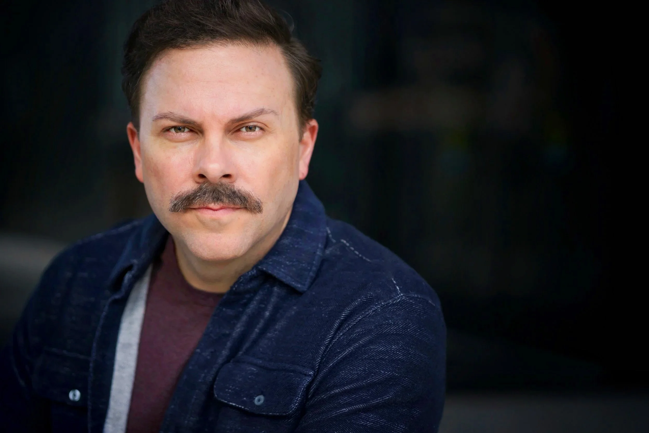 Matthew Cornwell headshot serious with mustache