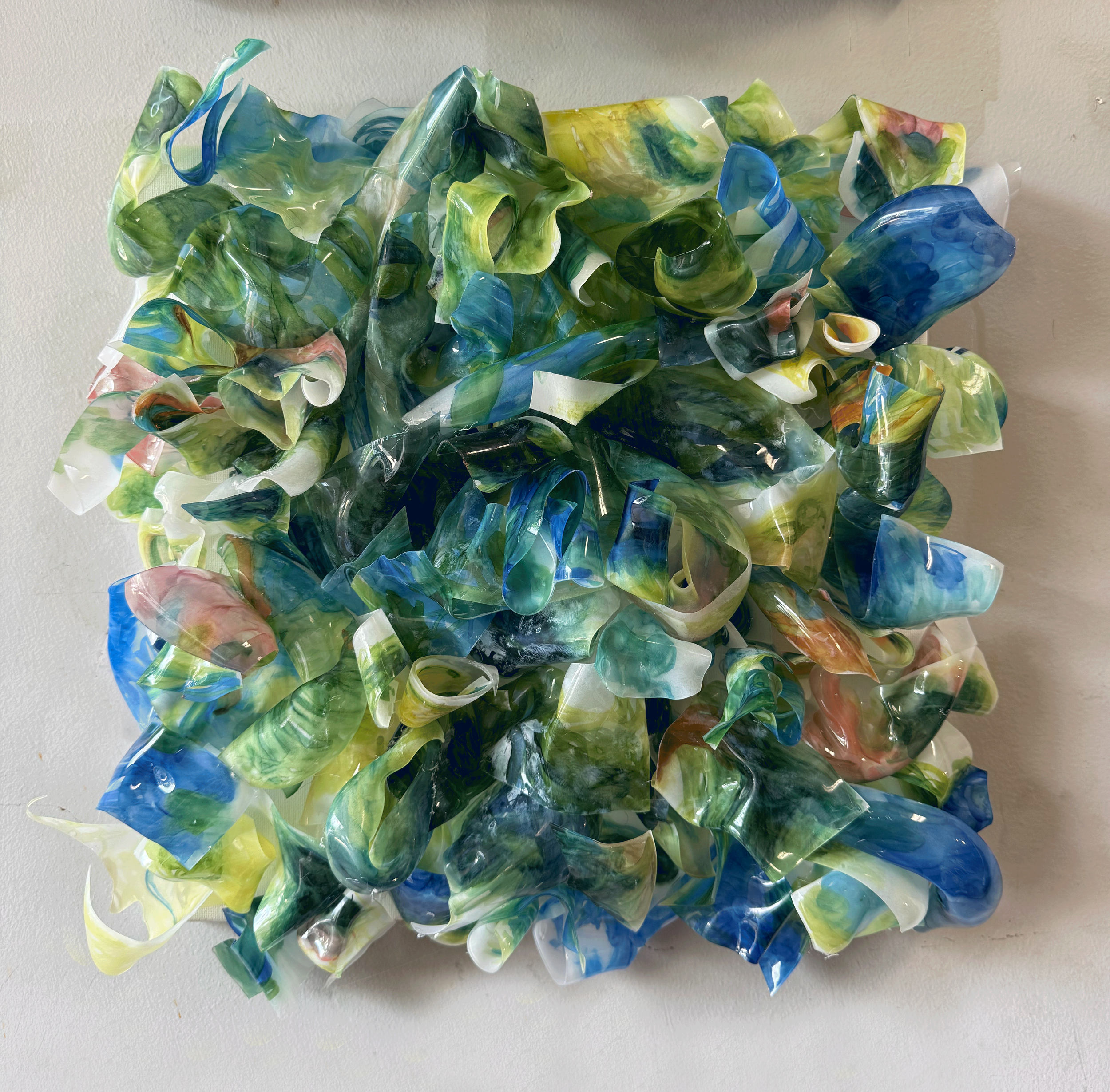 My mind is Made Color, 2026 // Acrylic on melted plastic // 14x14x4 cm // 35.5x35.5x10 cm
 