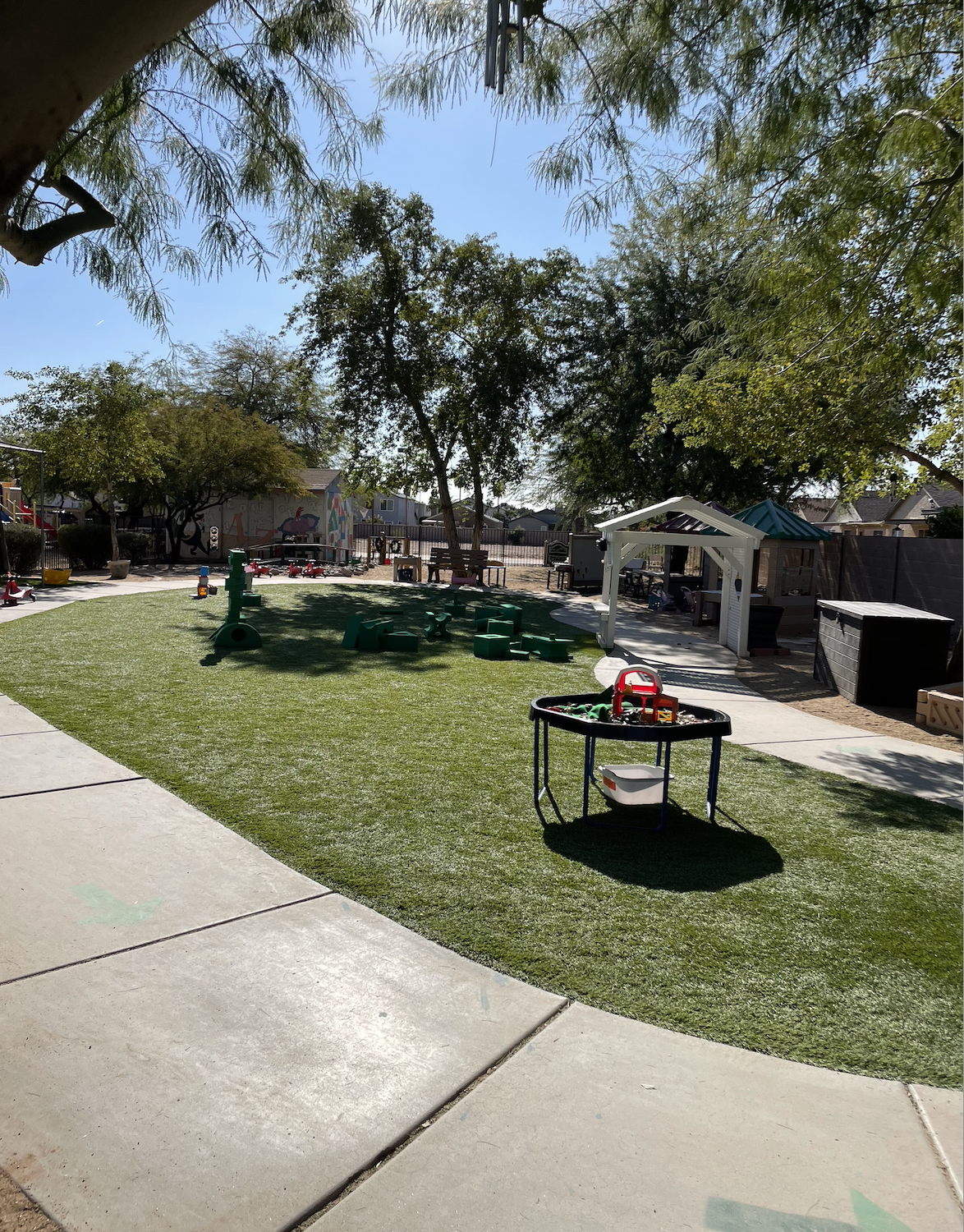 A serene outdoor grass area at the preschool, perfect for outdoor activities and exploration