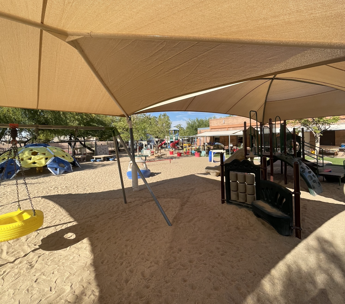 Expansive preschool playground featuring spacious open areas, colorful play structures, and inviting landscapes, designed to inspire exploration, creativity, and outdoor learning experiences