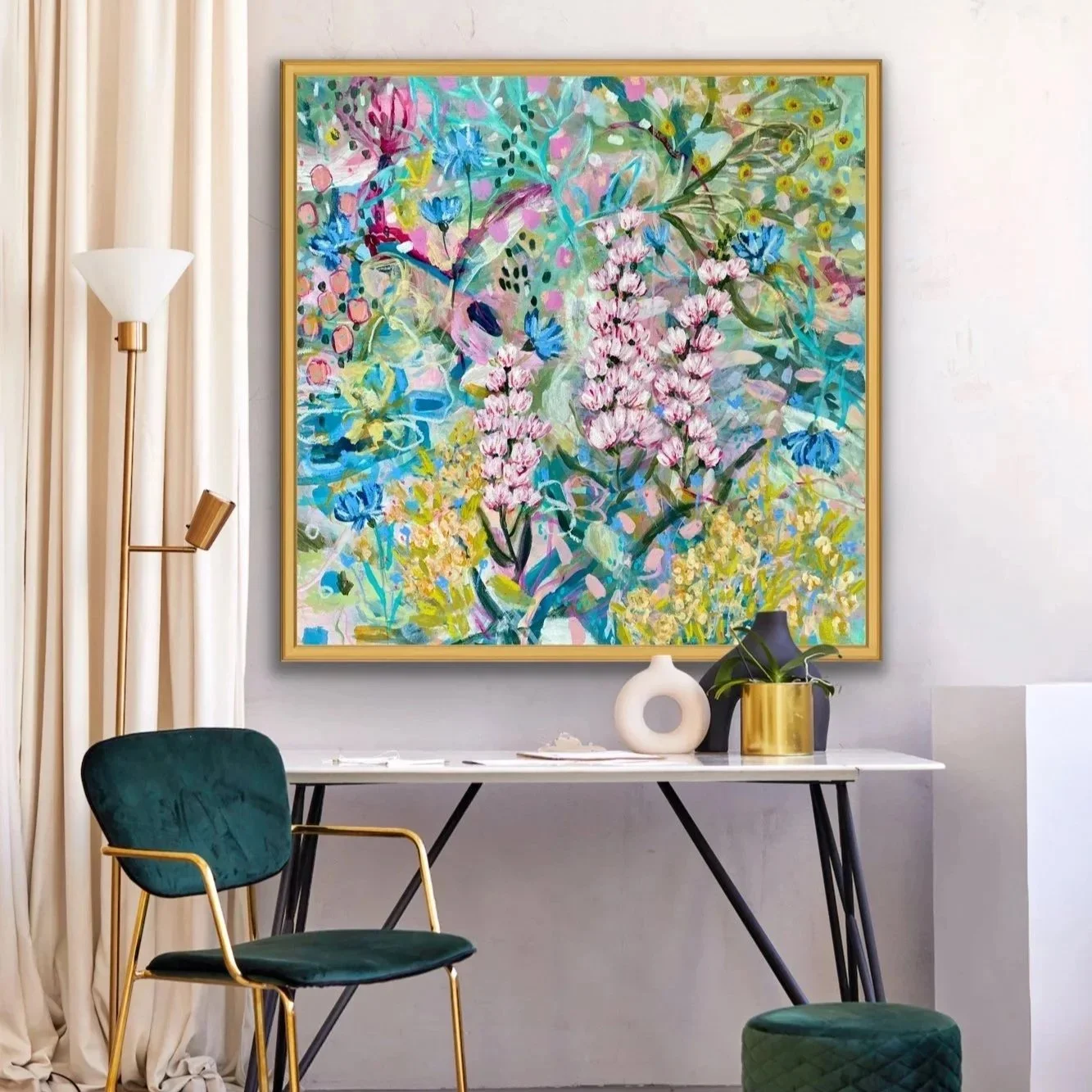 An abstract floral painting with pink, blue, yellow, and green colors hangs above a modern white desk, decorated with vases and a plant, in a contemporary room.
