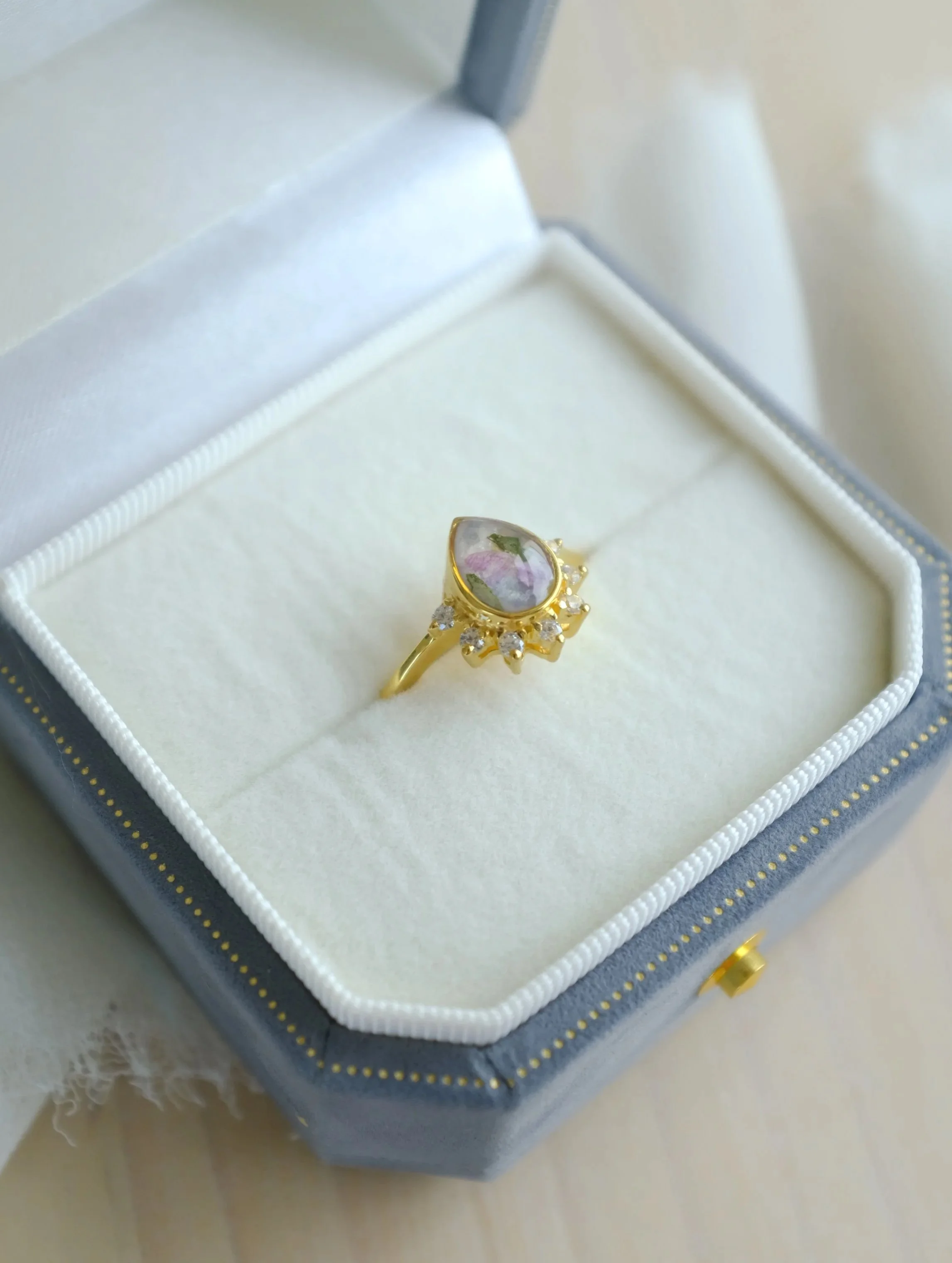 Gold Ring with bits of petals in the gem stone