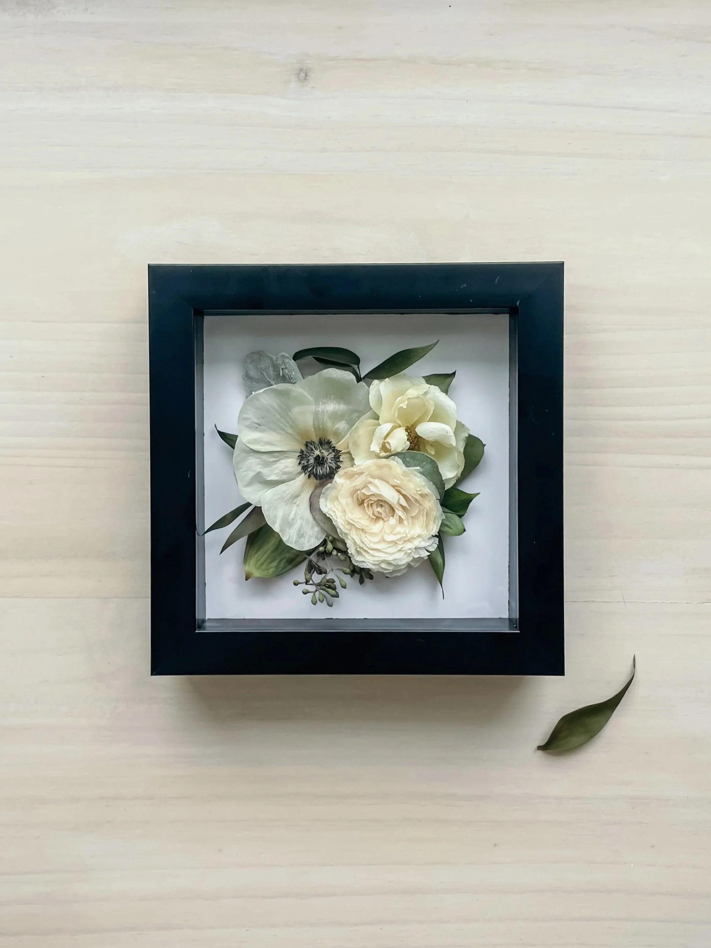 white flowers in a black frame