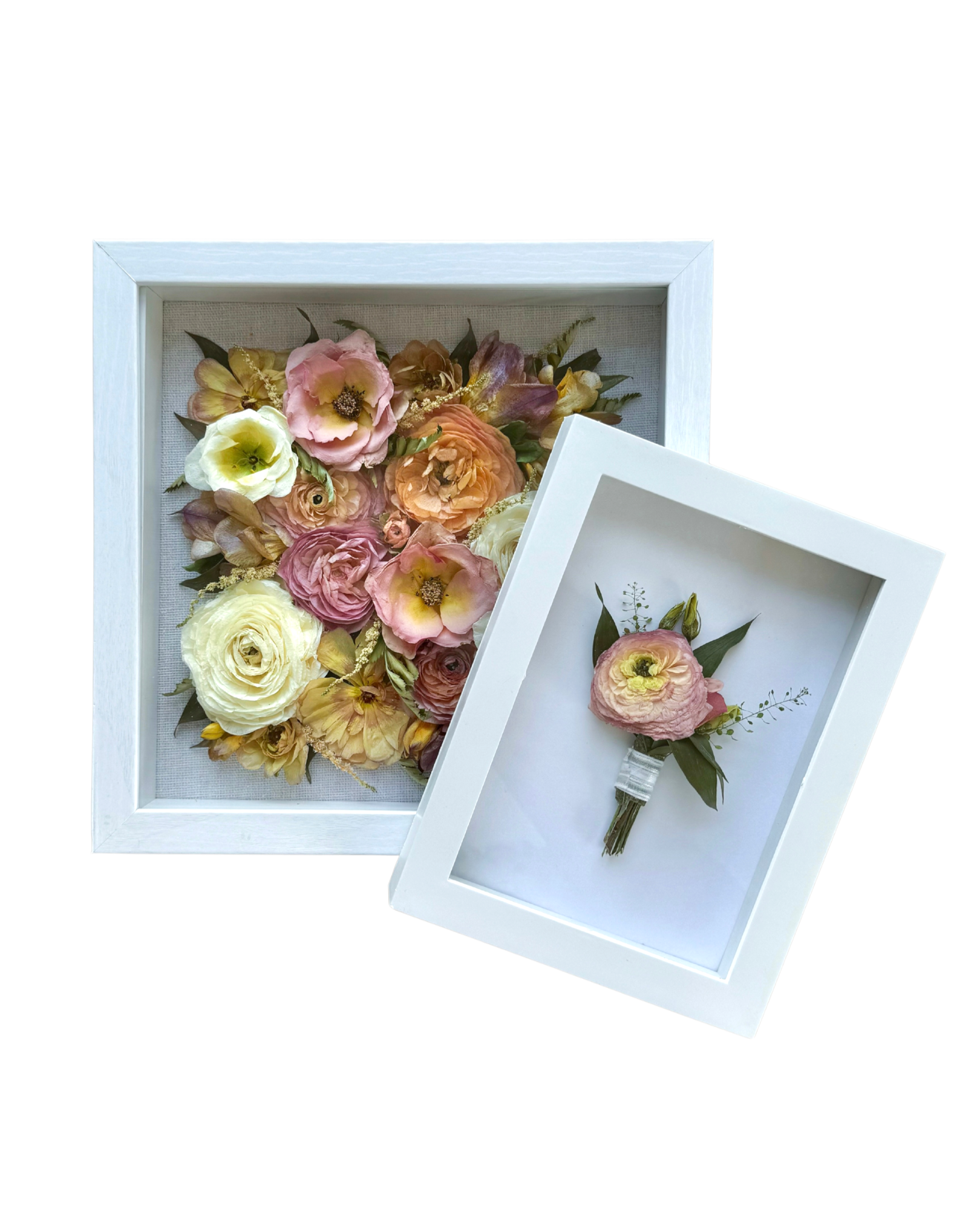 Two white picture frames, one containing a floral arrangement of pink, yellow, and cream flowers, and the other with a pink flower boutonniere on a white background.