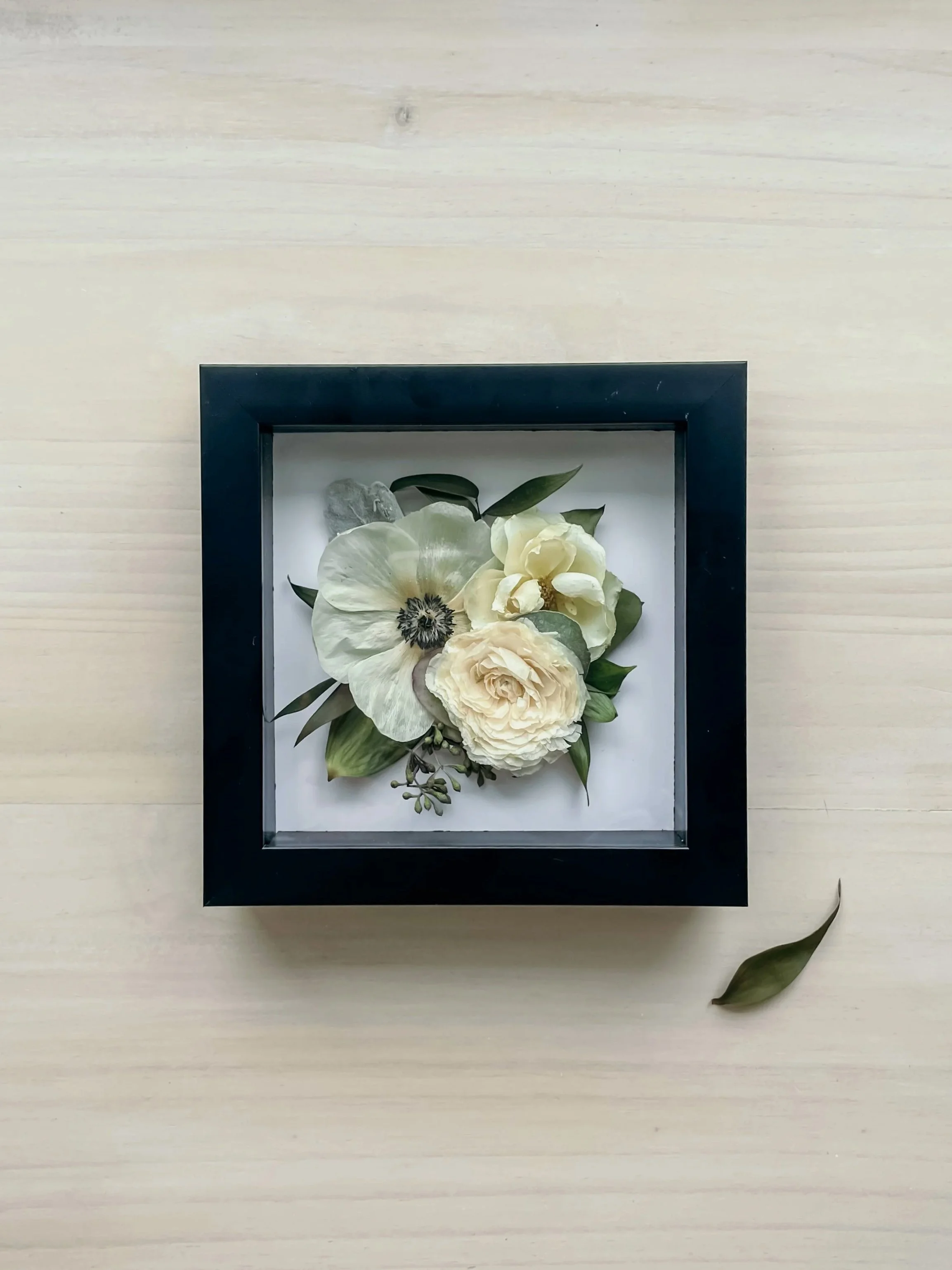 white flowers in a black frame