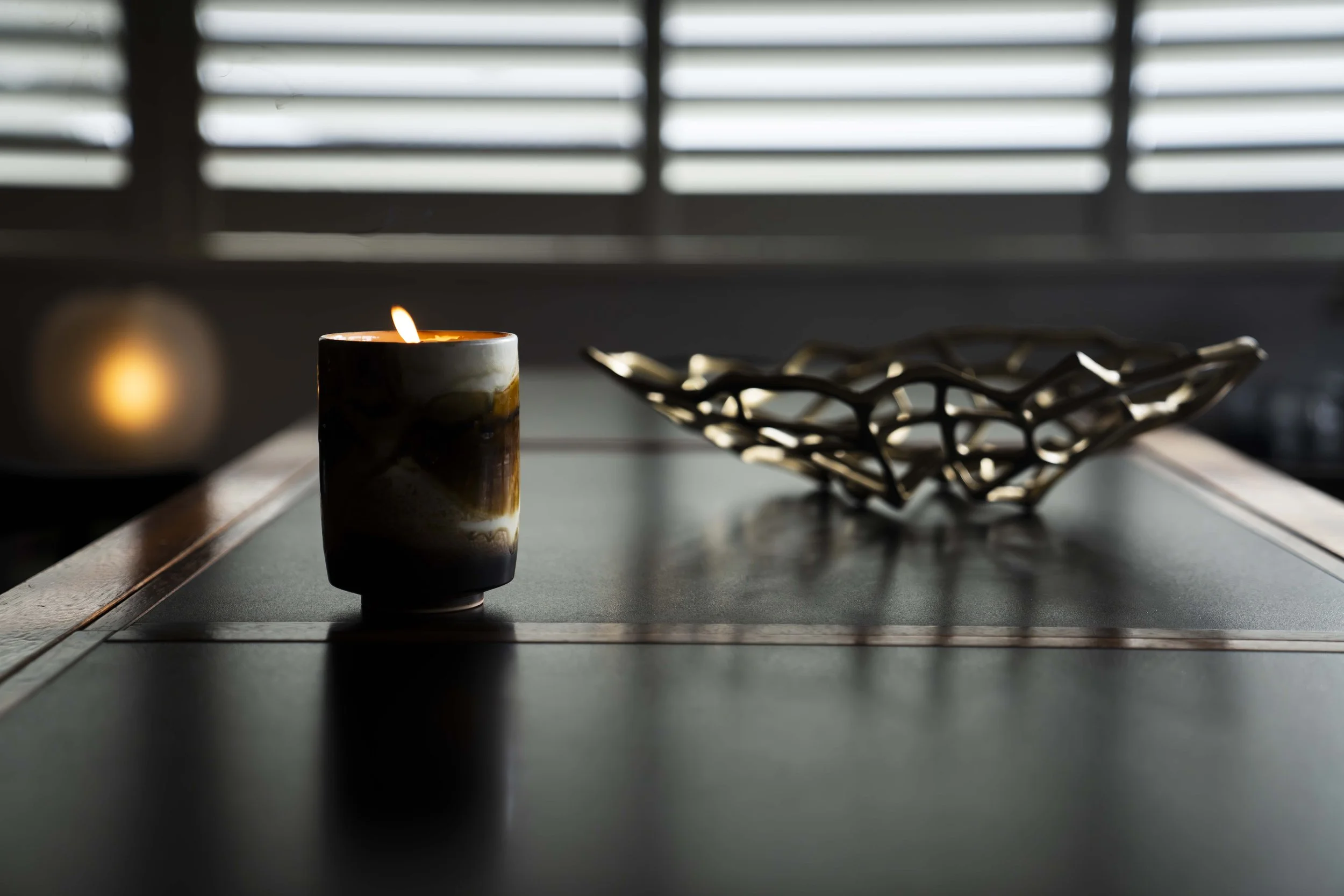 The Tom Dixon bone bowl creates a dramatic presence, which is softened by the tactile ambience of a gorgeous ceramic candle.