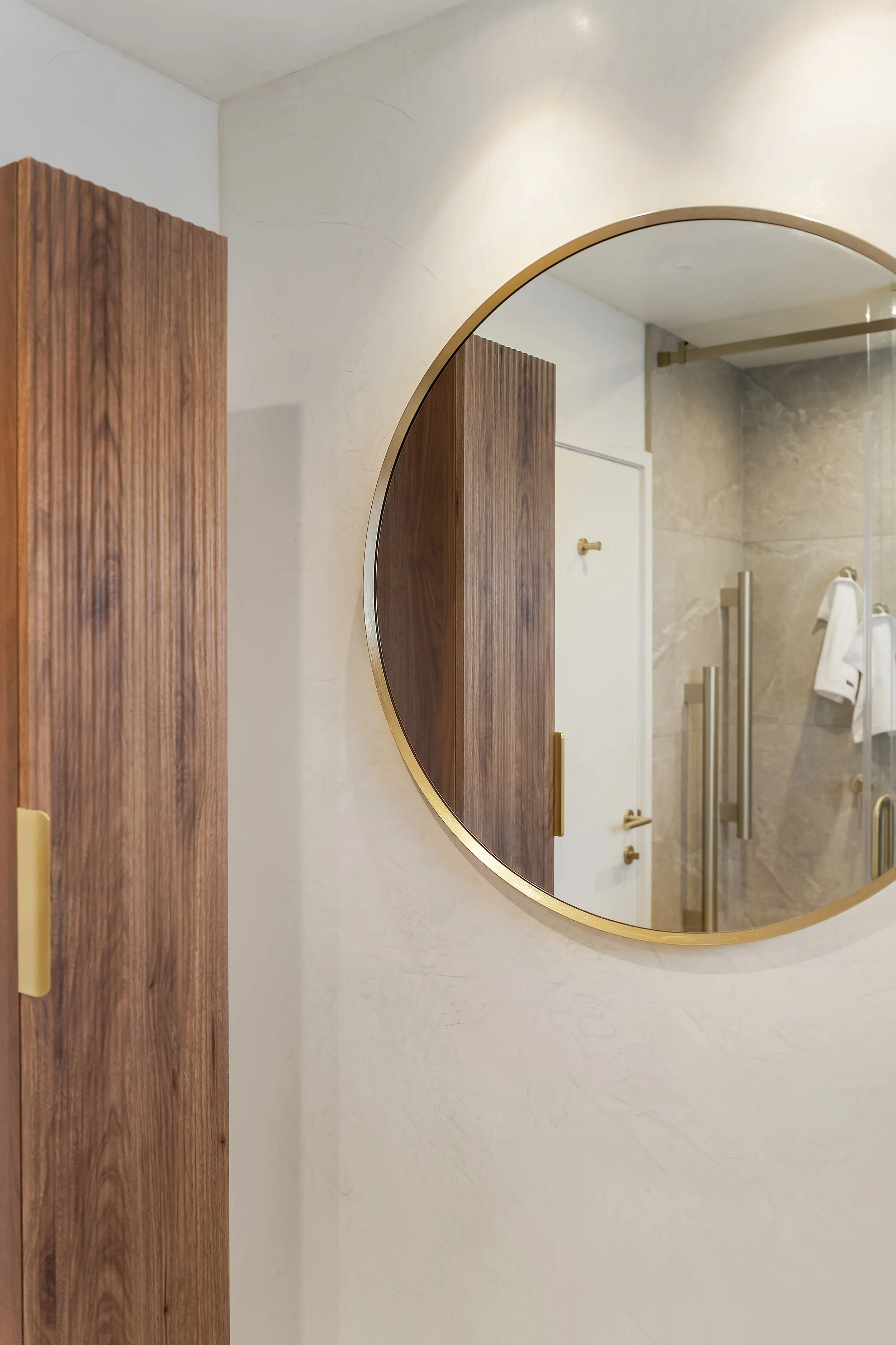 Clever use of space allowed us to integrate a simple wooden vanity and tower cabinet that evokes a driftwood, beachy feel. The fresco-waxed walls and ceiling—which are as durable as they are beautiful. This curated mix, which seamlessly blends with b