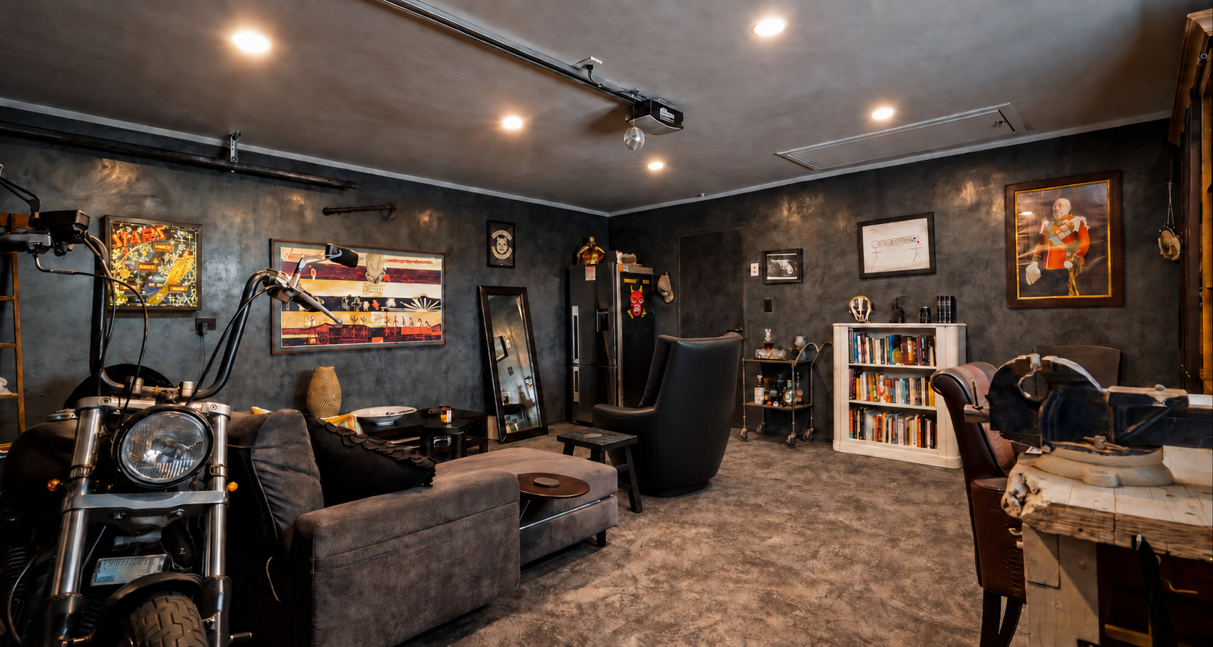 This space combines work and play, featuring a lounge area with a large frame TV for PlayStation entertainment and a practical workbench for his various hobbies. His treasures are elegantly displayed behind glass. The goal was to blend old and new el