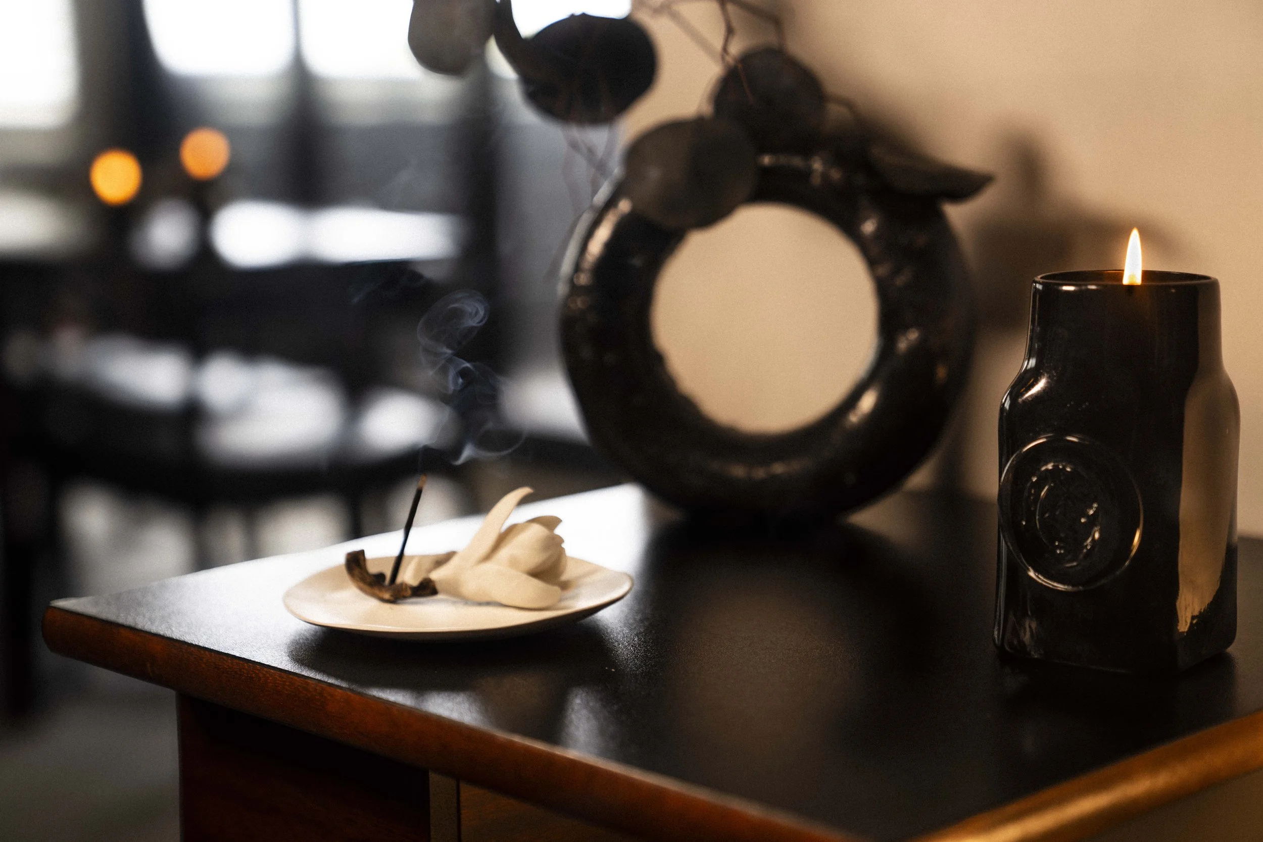 The cleverly designed Bernard Vuarnesson adjustable side table is adorned with beautifully curated elements.