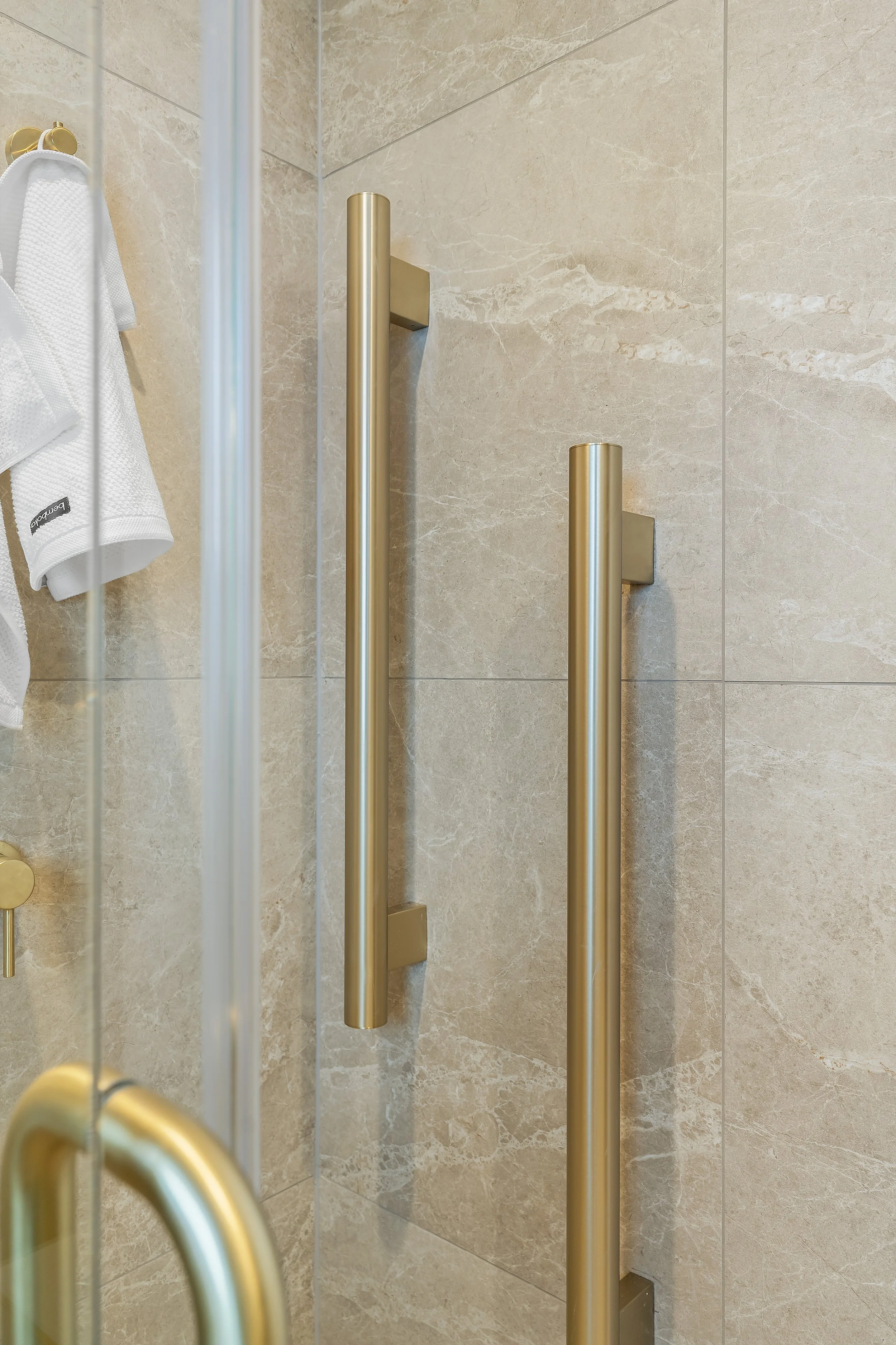 Brushed brass finishes are the perfect accent, introducing a subtle touch of luxury and timelessness into this charming, compact bathroom.