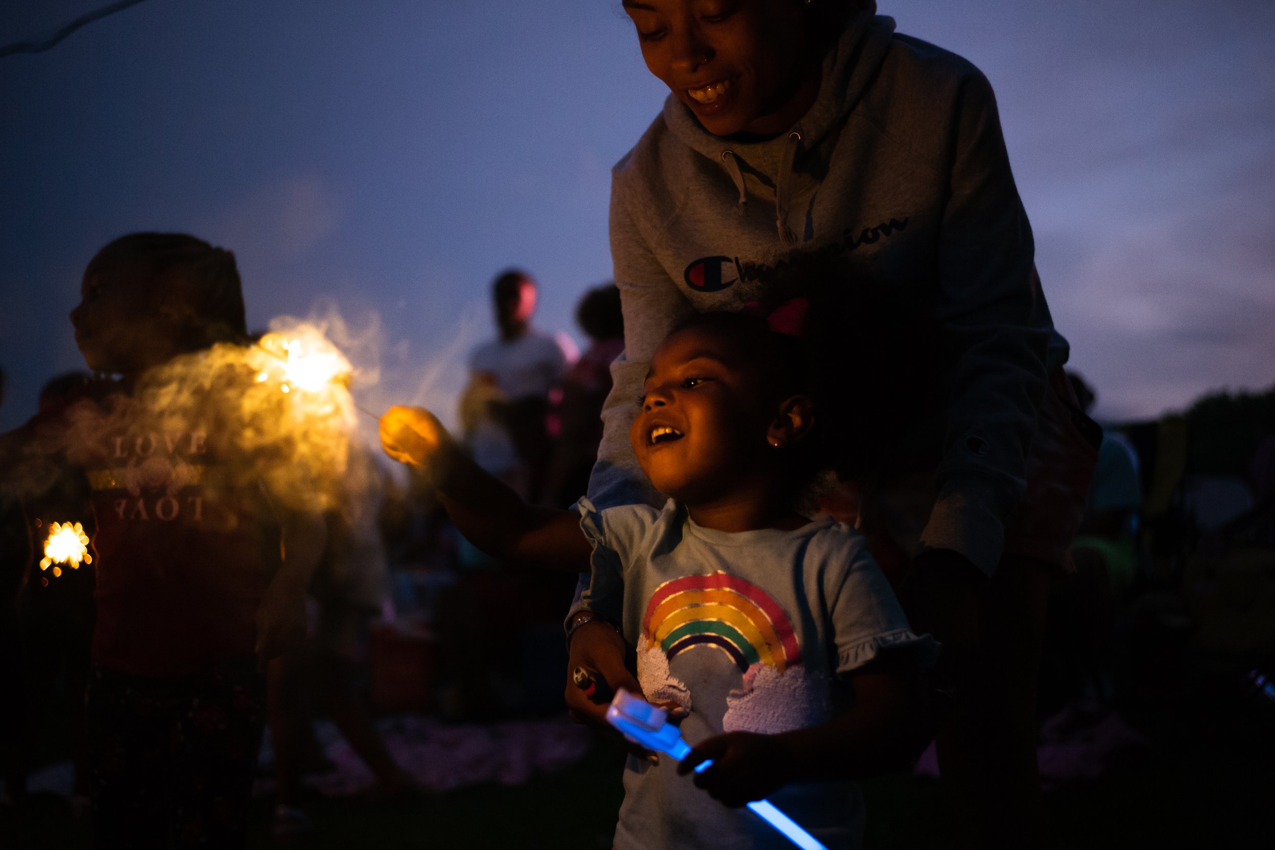  The Lauwers family lights up sparklers at the Whitmore Lake Fireworks celebration on July 2, 2022. 