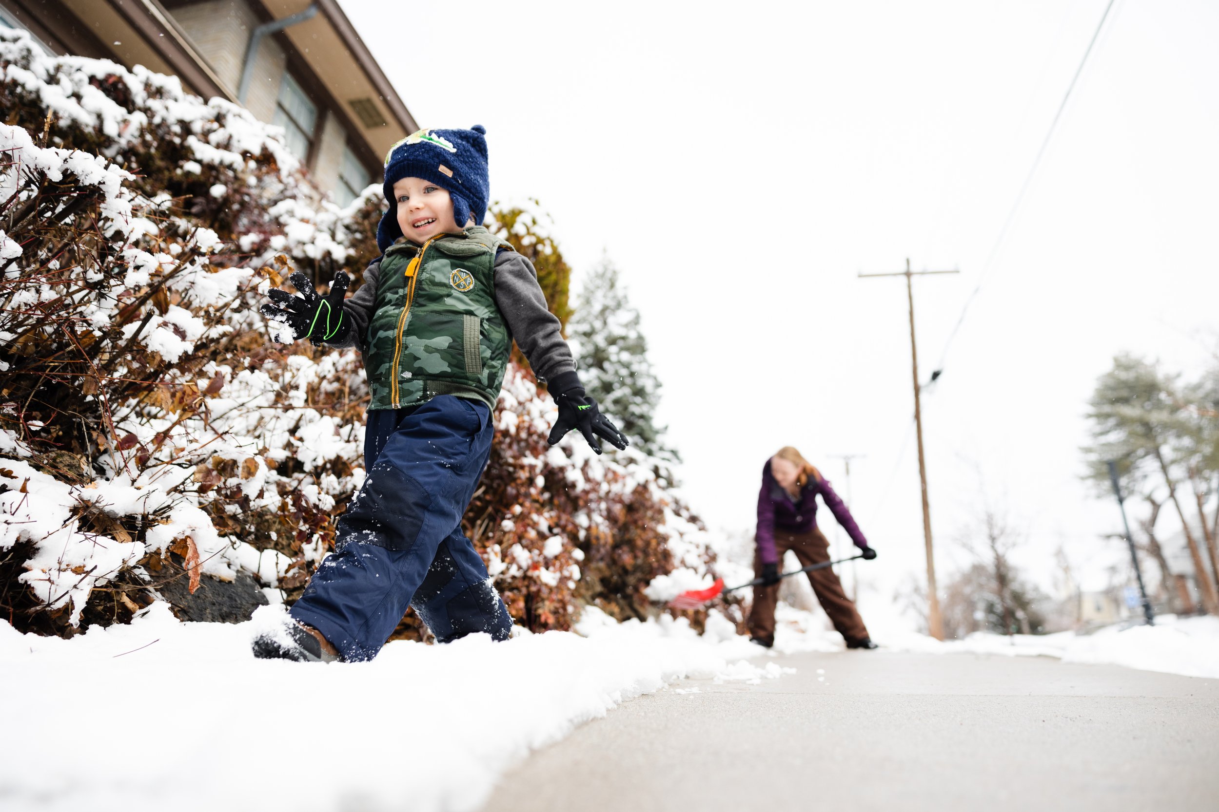  Sebastian Stephenson, 3, plays with snow as his mother Whitney Stephenson shovels her sidewalk after a record breaking snowfall in Salt Lake City on March 24, 2023.  