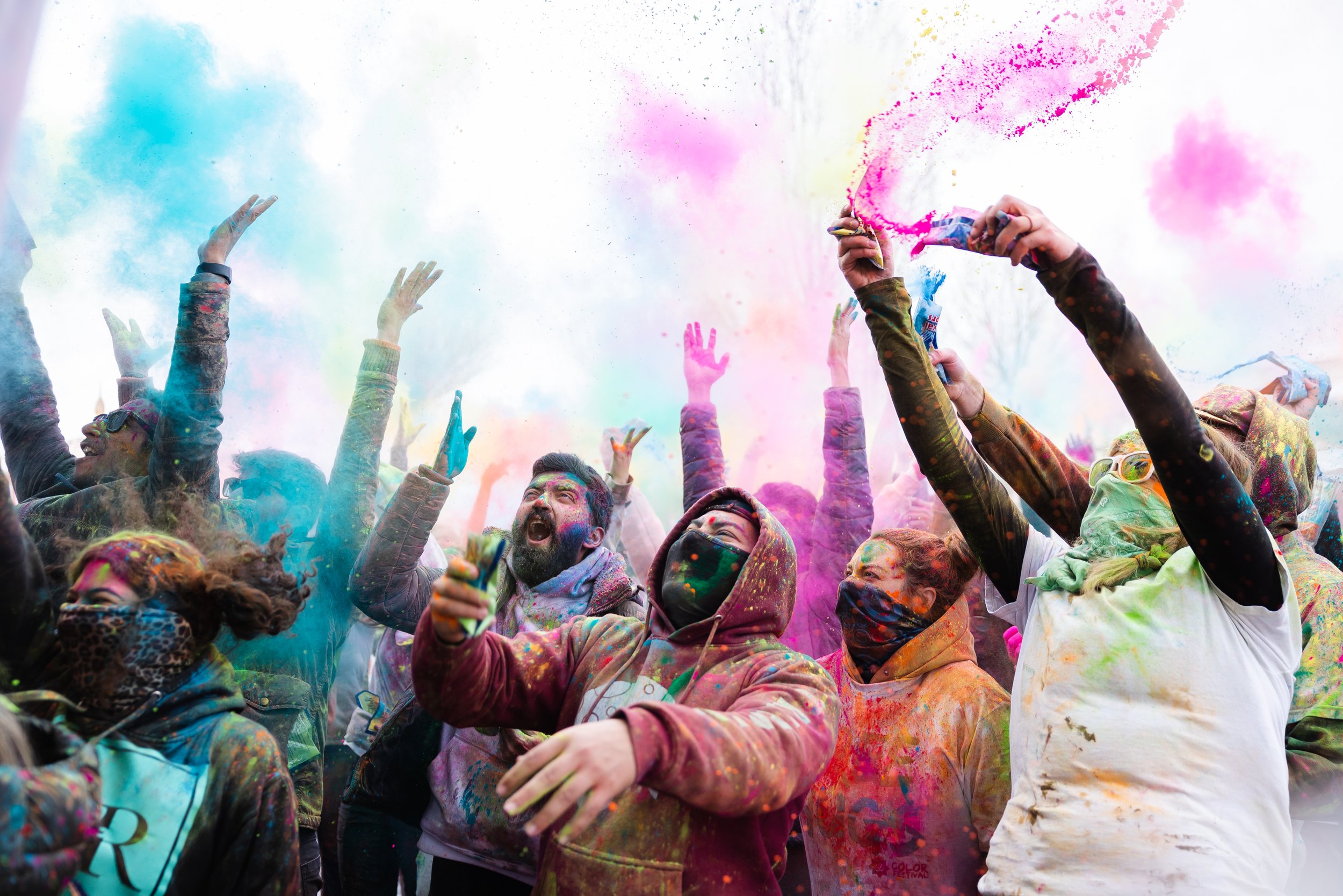  Attendees cheer and throw colored powder in the air during the Holi Festival of Color at the Krishna Temple in Spanish Fork on March 26, 2023.  