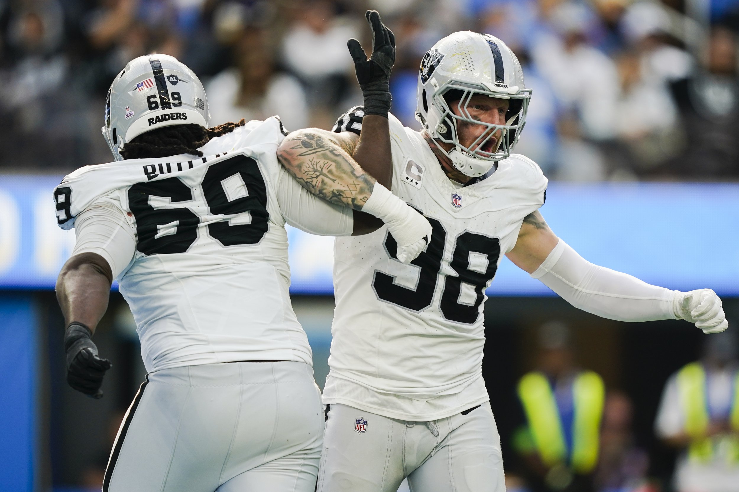  Las Vegas Raiders defensive end Maxx Crosby (98) celebrates with defensive tackle Adam Butler (69) after Crosby's sack on Los Angeles Chargers quarterback Justin Herbert during the second half of an NFL football game Sunday, Oct. 1, 2023, in Inglewo