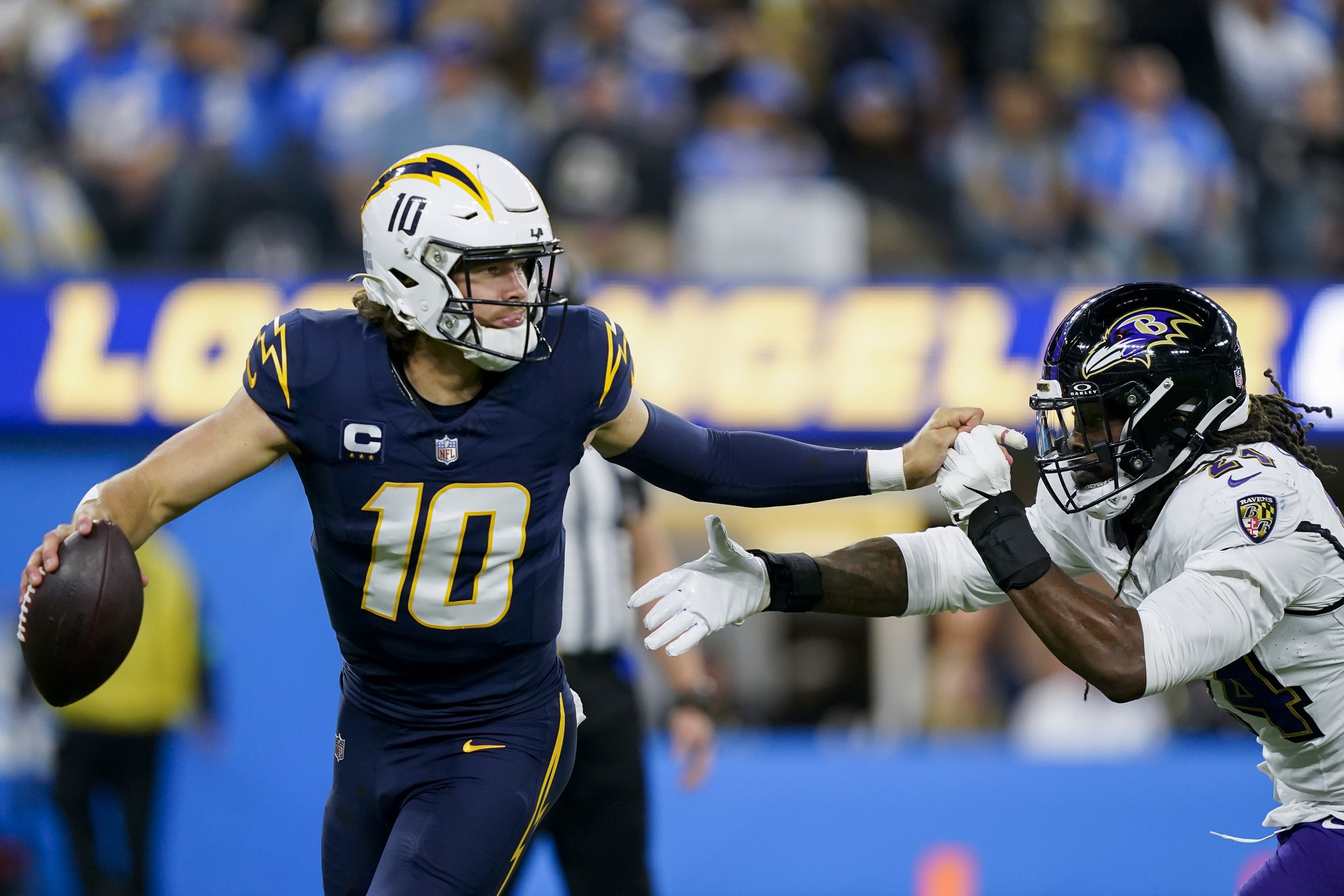  Los Angeles Chargers quarterback Justin Herbert (10) is pressured by Baltimore Ravens linebacker Jadeveon Clowney (24) during the first half of an NFL football game Sunday, Nov. 26, 2023, in Inglewood, Calif. 