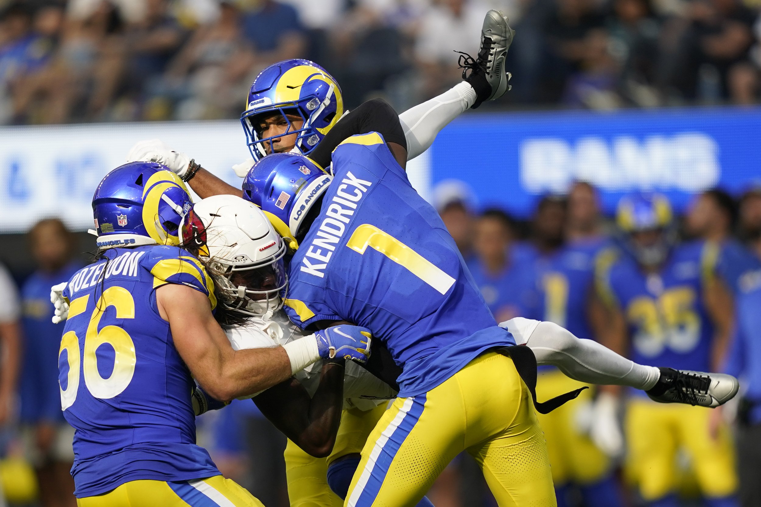  Arizona Cardinals wide receiver Marquise Brown (2), center, is tackled by Los Angeles Rams cornerback Ahkello Witherspoon, top, linebacker Christian Rozeboom (56) and cornerback Derion Kendrick (1), during the second half of an NFL football game Sun