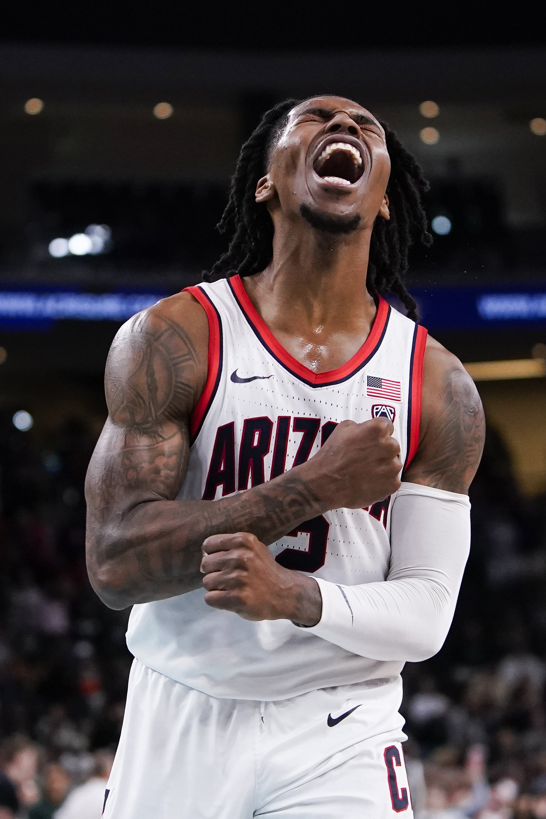  Arizona guard Caleb Love reacts after making a buzzer-beater 3-point basket to end the first half of an NCAA college basketball game against Michigan State, Thursday, Nov. 23, 2023, in Palm Desert, Calif. 