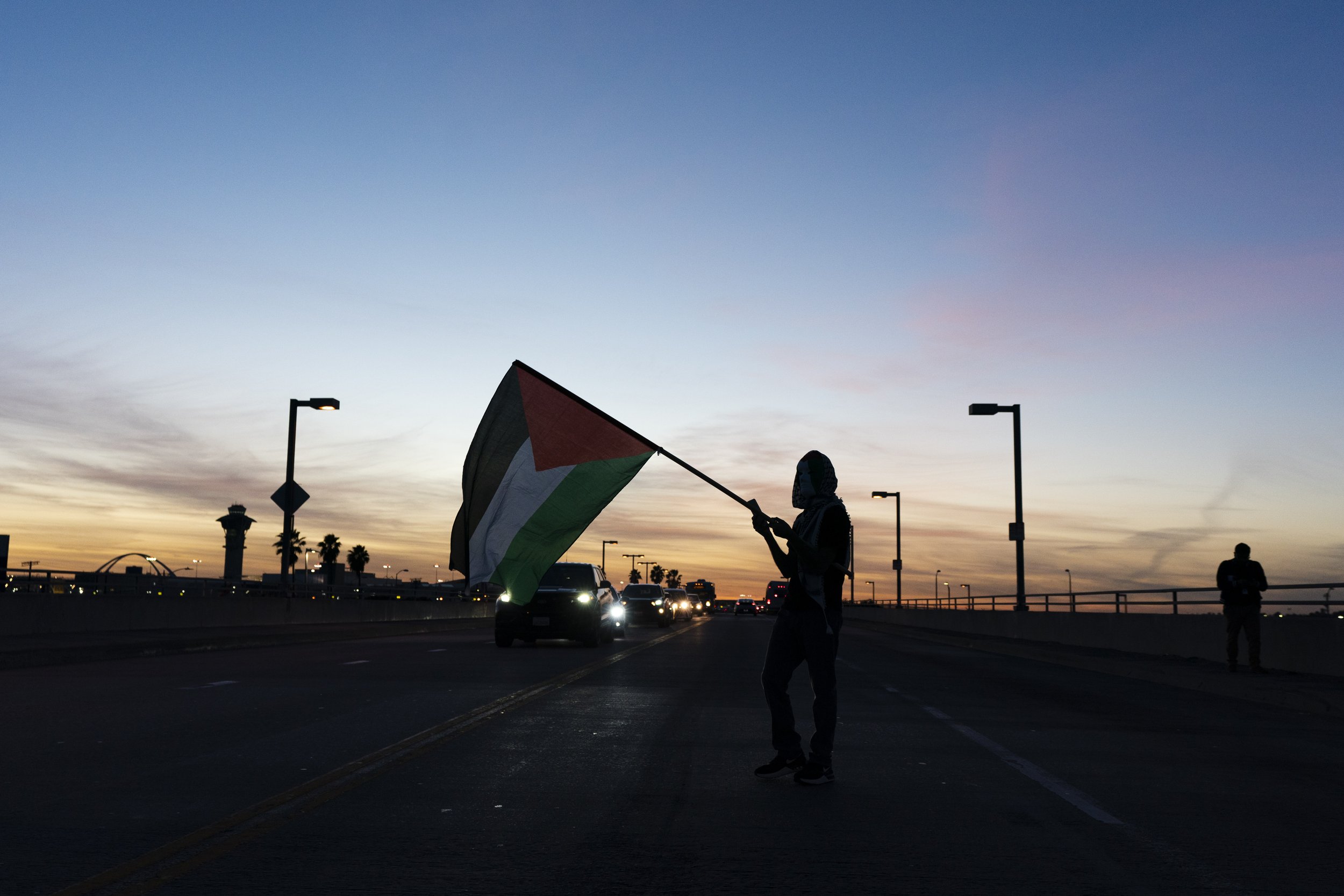  A protester waves a Palestinian flag during a rally in support of Palestinians, and calling for an immediate ceasefire in Gaza, Friday, Dec. 15, 2023, in Los Angeles. 