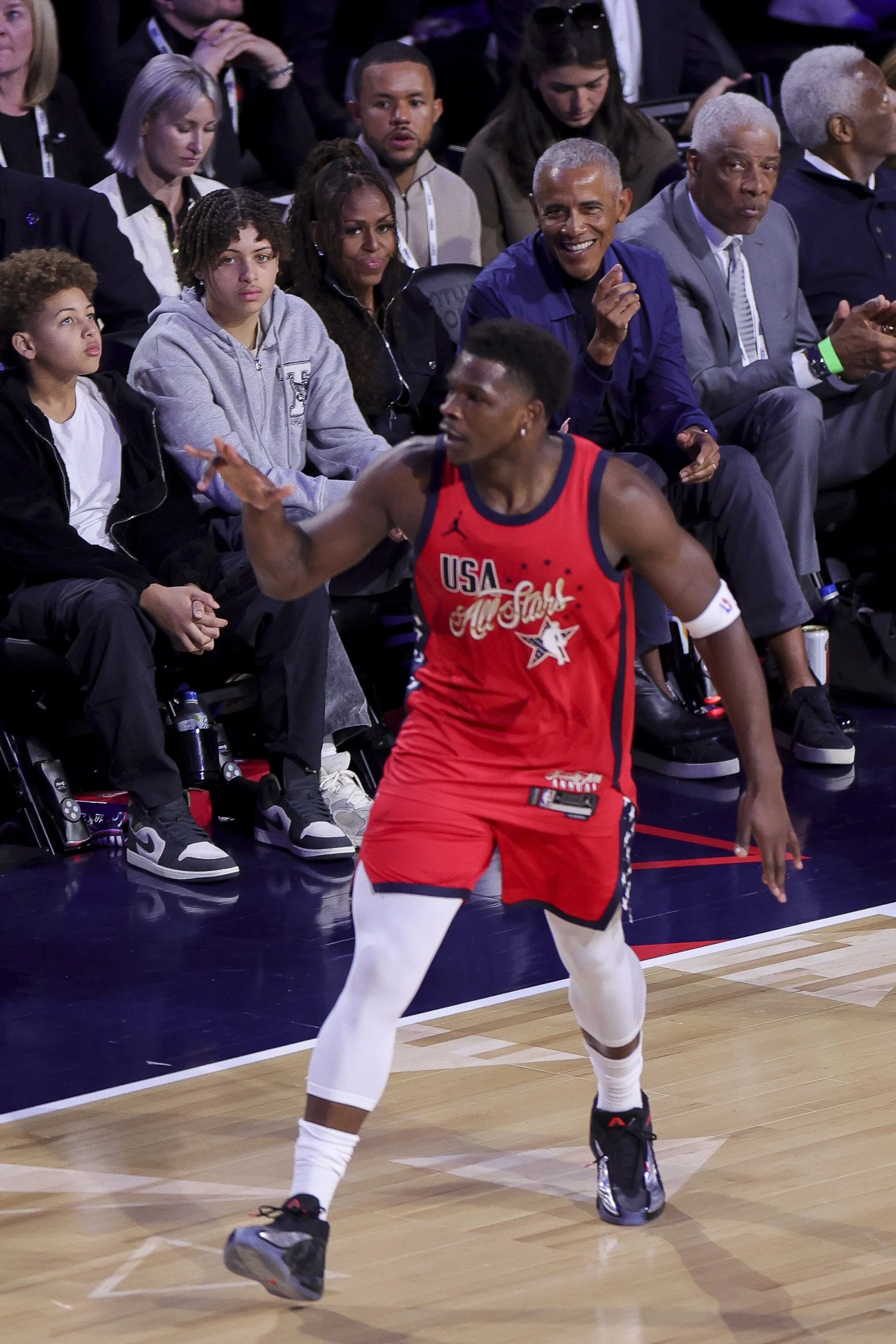  Former President Barack Obama and his wife, Michelle Obama, watch as Anthony Edwards #5 of the Minnesota Timberwolves celebrates after making a three-point basket during the 75th NBA All-Star Game at the Intuit Dome in Inglewood, California. 