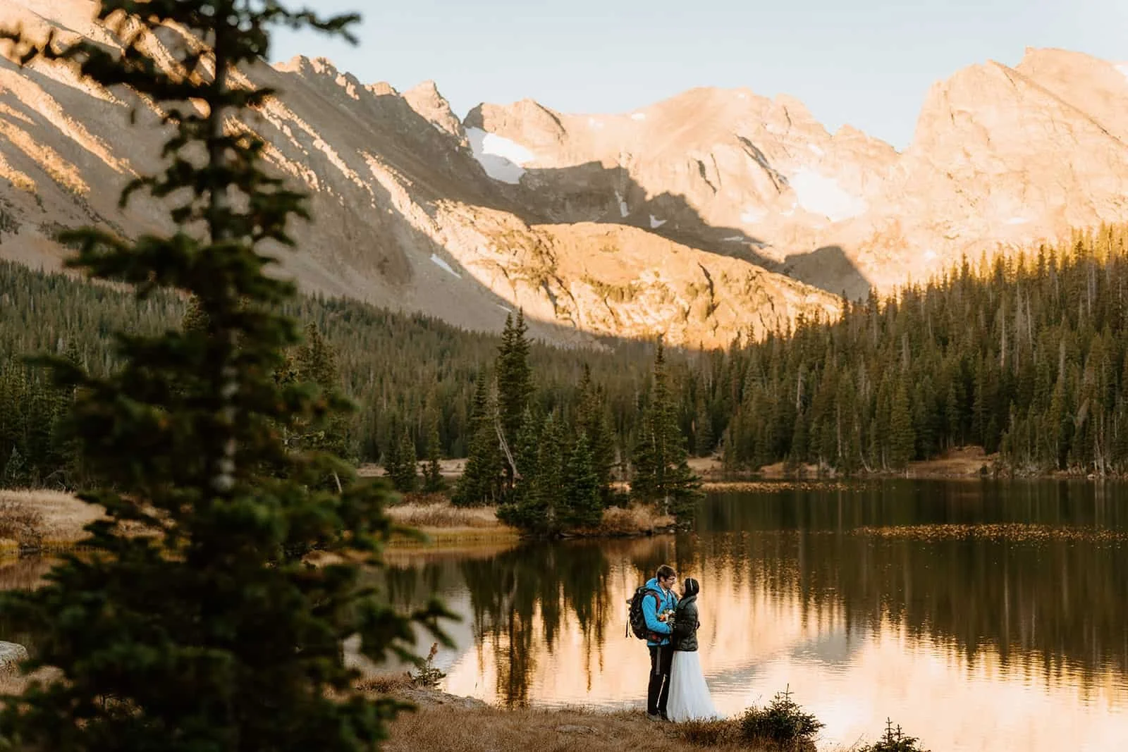 Couple in wedding attire at Brainard Lake at sunset during a fall Colorado elopement near Boulder