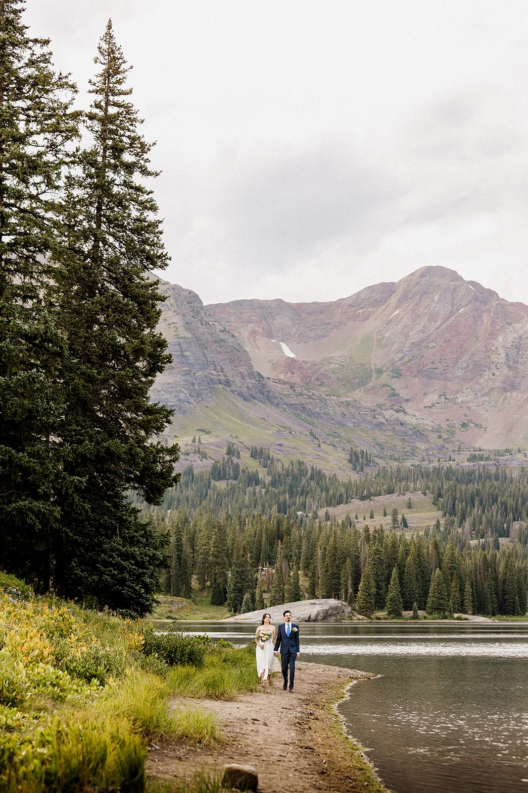 Couples walks beside the lakeshore in crested butte