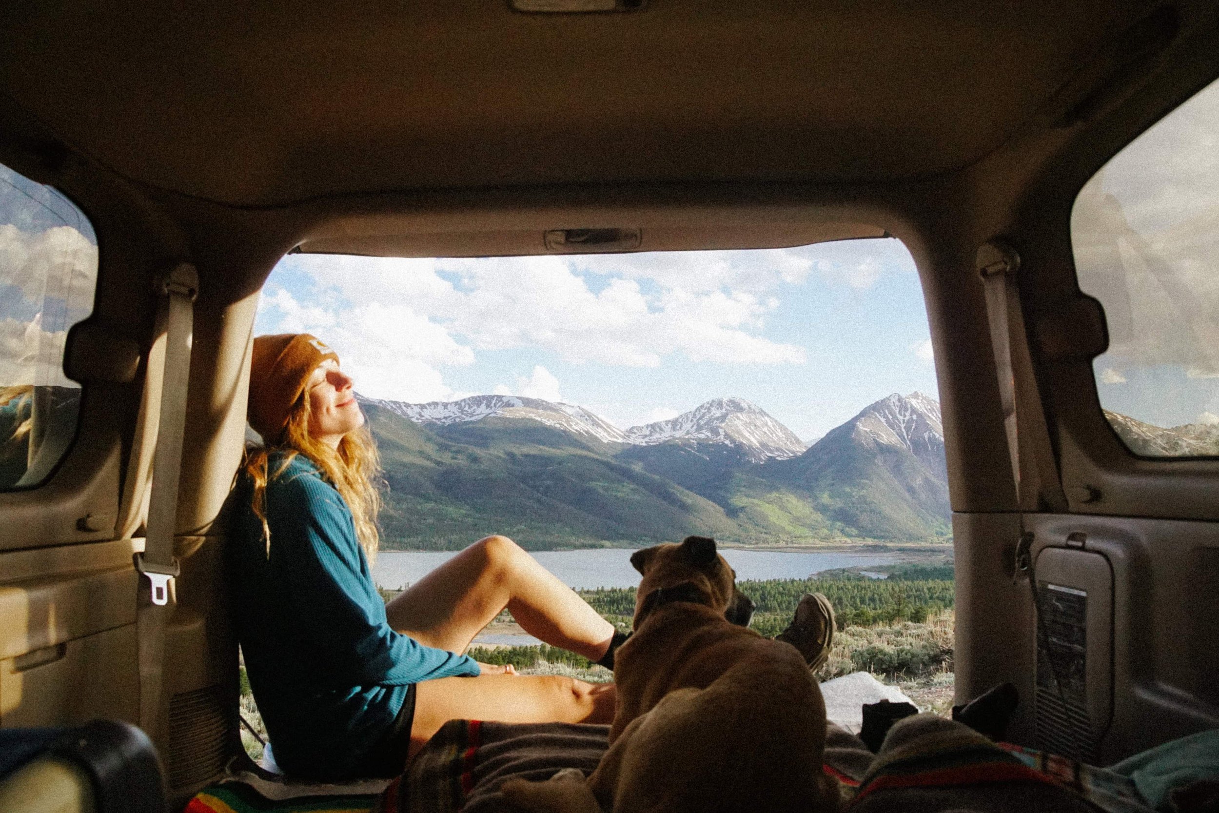 Kimberly Crist and her dog Flapjack with the car packed for an elopement