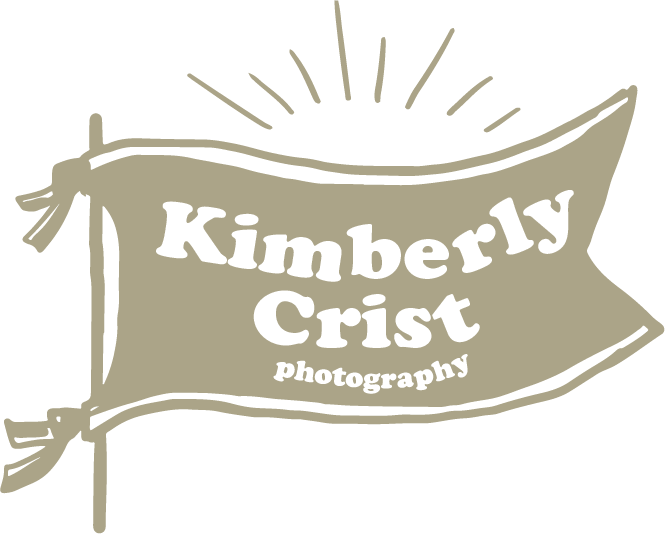 Logo for Kimberly Crist Photography featuring a stylized flag design with the name and photography service.