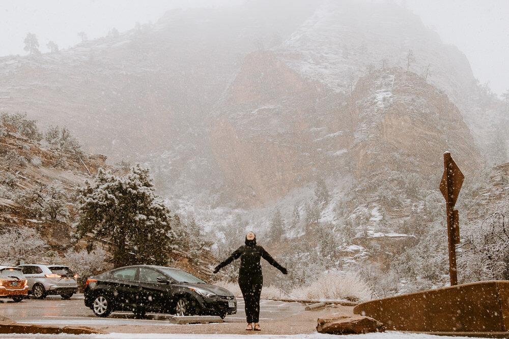 Person standing in a snowy parking lot