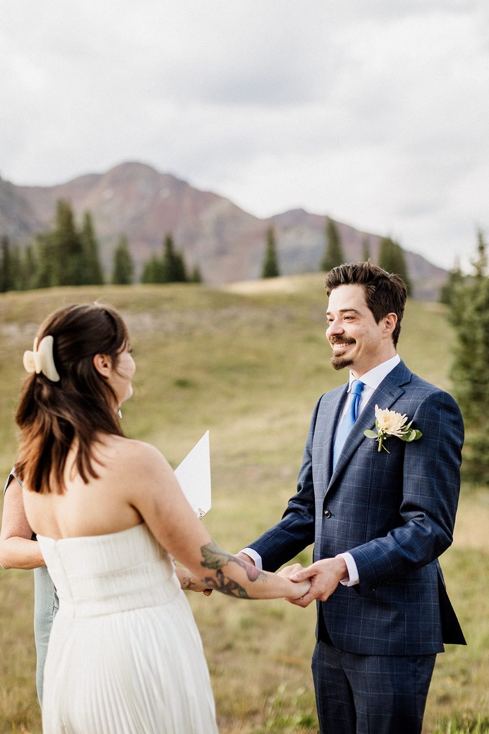 Bride and groom hold hands during their ceremony