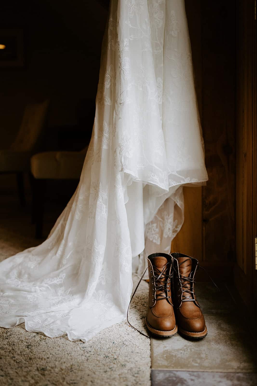 a white wedding dress hangs over redwing boots