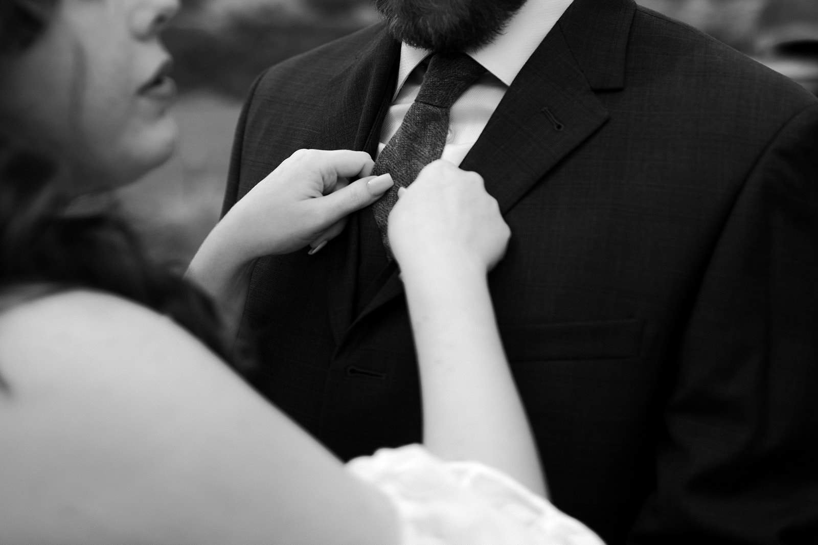 A woman fixes a mans tie