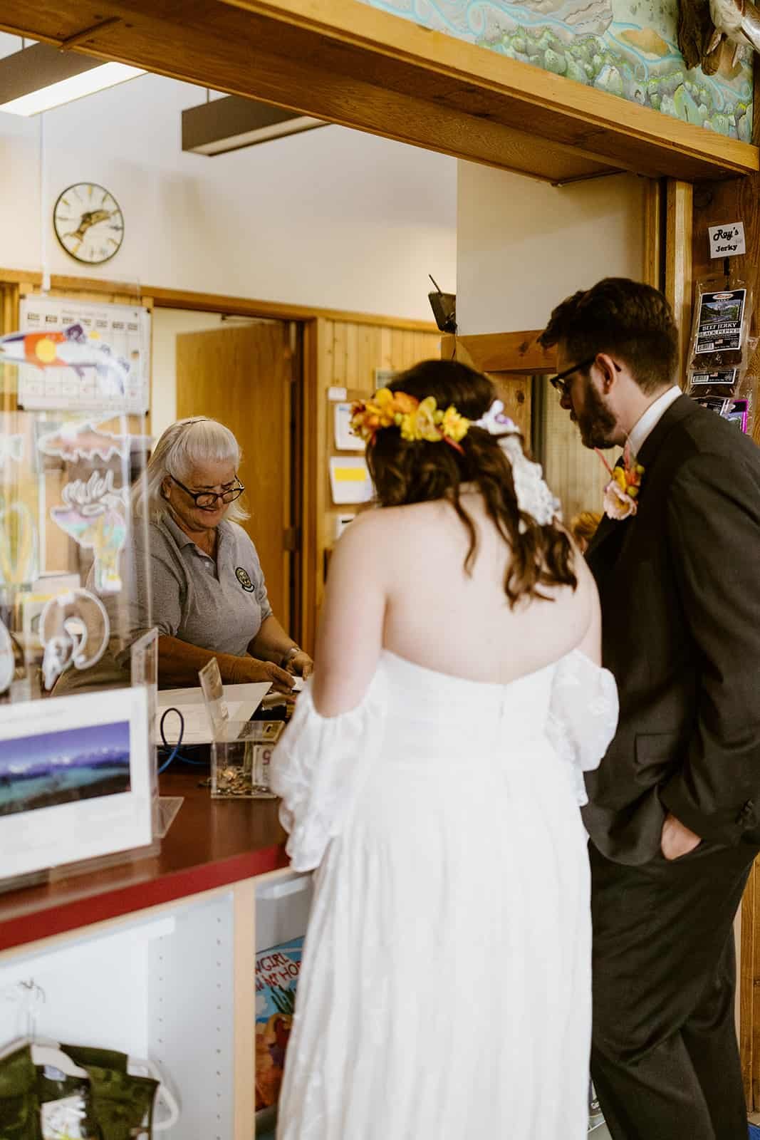 A newly married couple walks into the Ridgway State Park visitor center