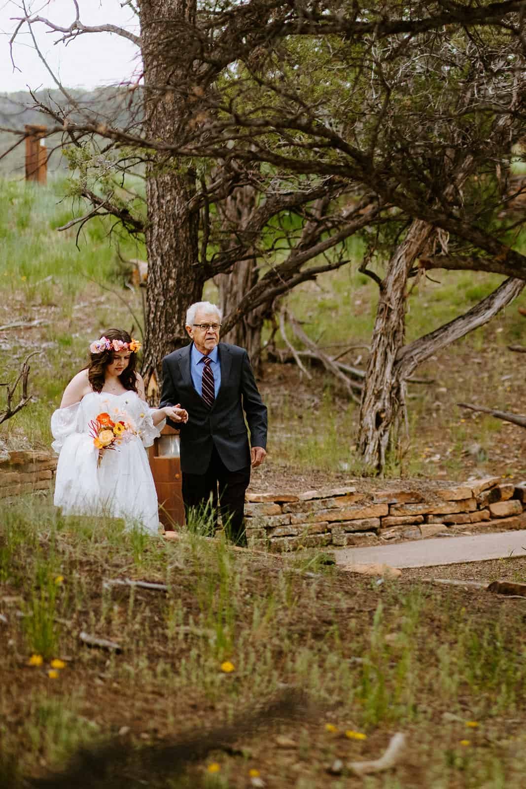 A father walks his daughter down the wedding aisle at Ridgway State Park