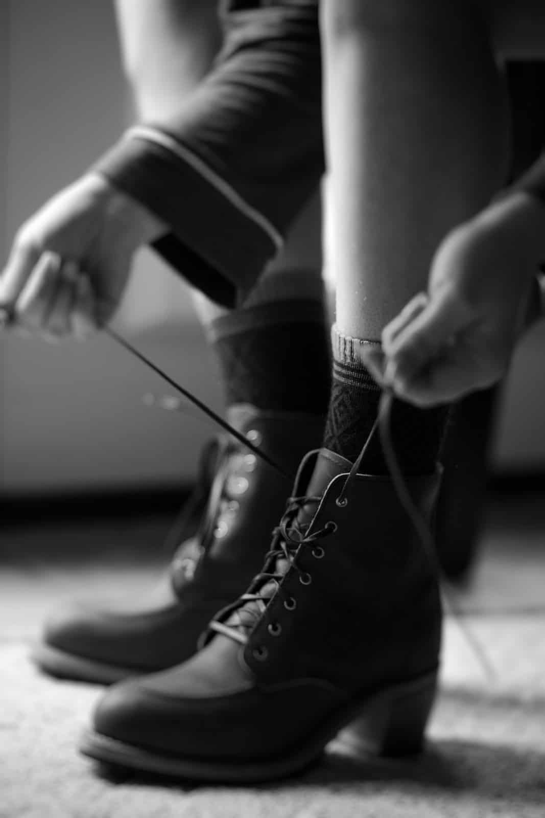 A woman ties her Redwing boots