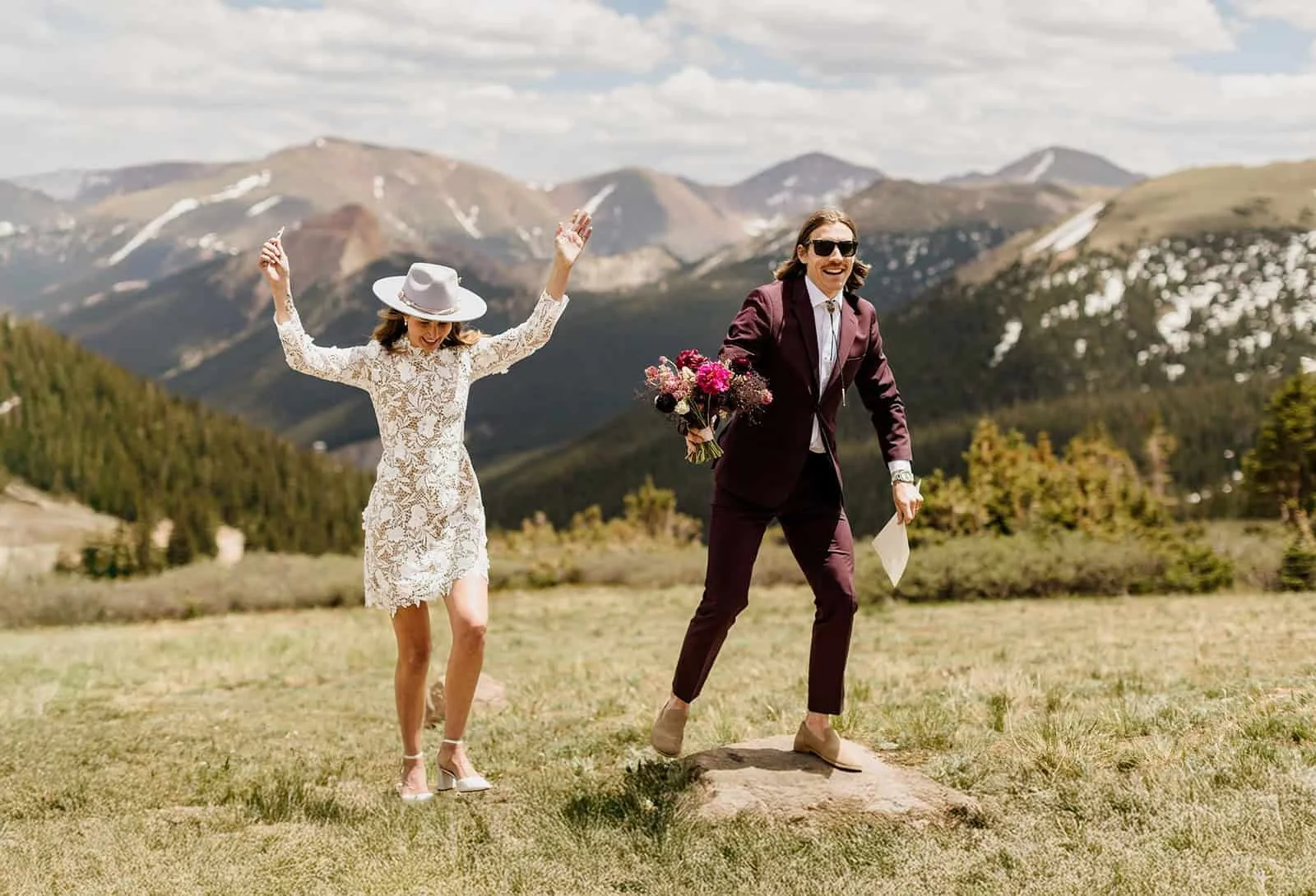 Couple in wedding attire celebrating their elopement at A-Frame Club in Winter Park, Colorado