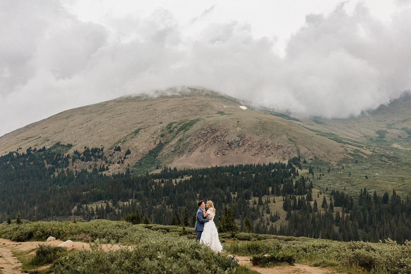 Couple exchanging vows at a drive-up mountain overlook in Colorado during sunset.