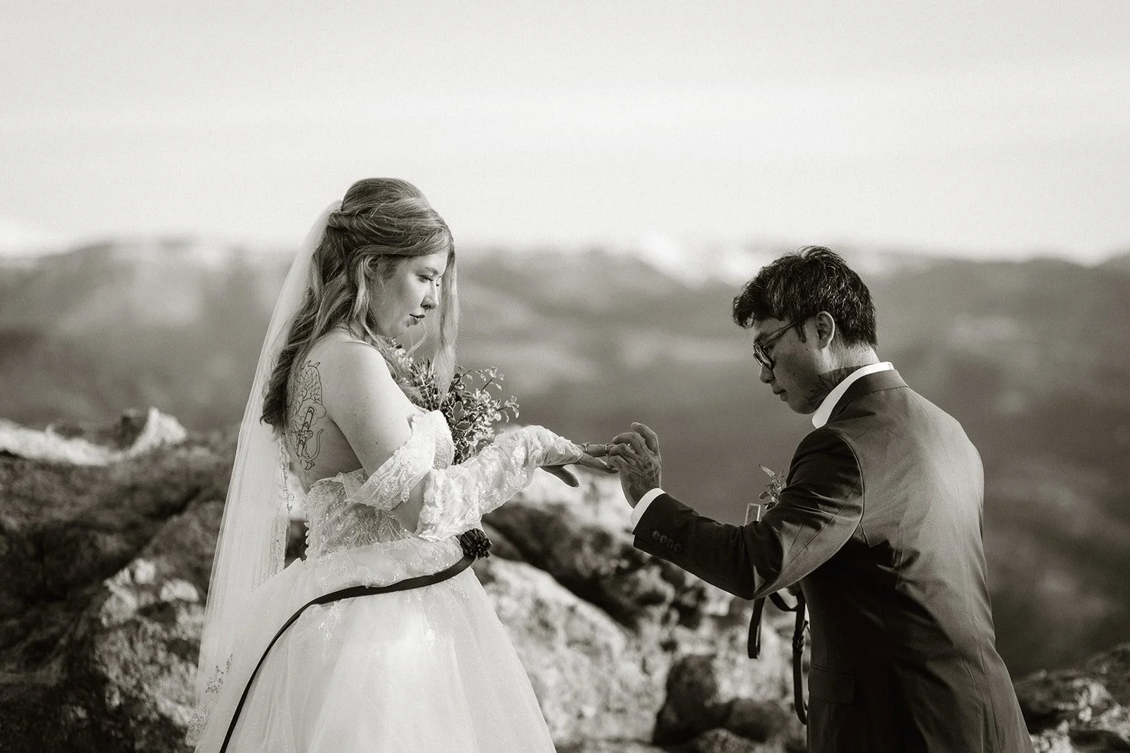 Ring exchange at a Boulder elopement, in black and white