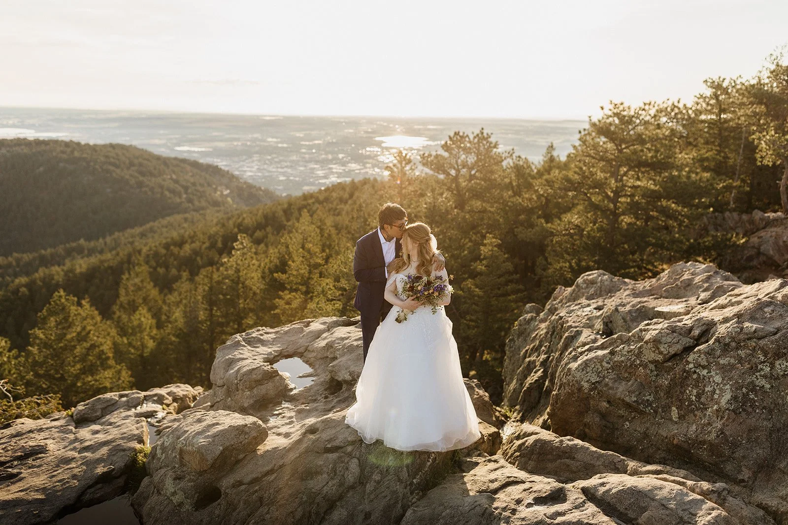Couple kissing on the rocks at Lost Gulch Overlook in early morning light