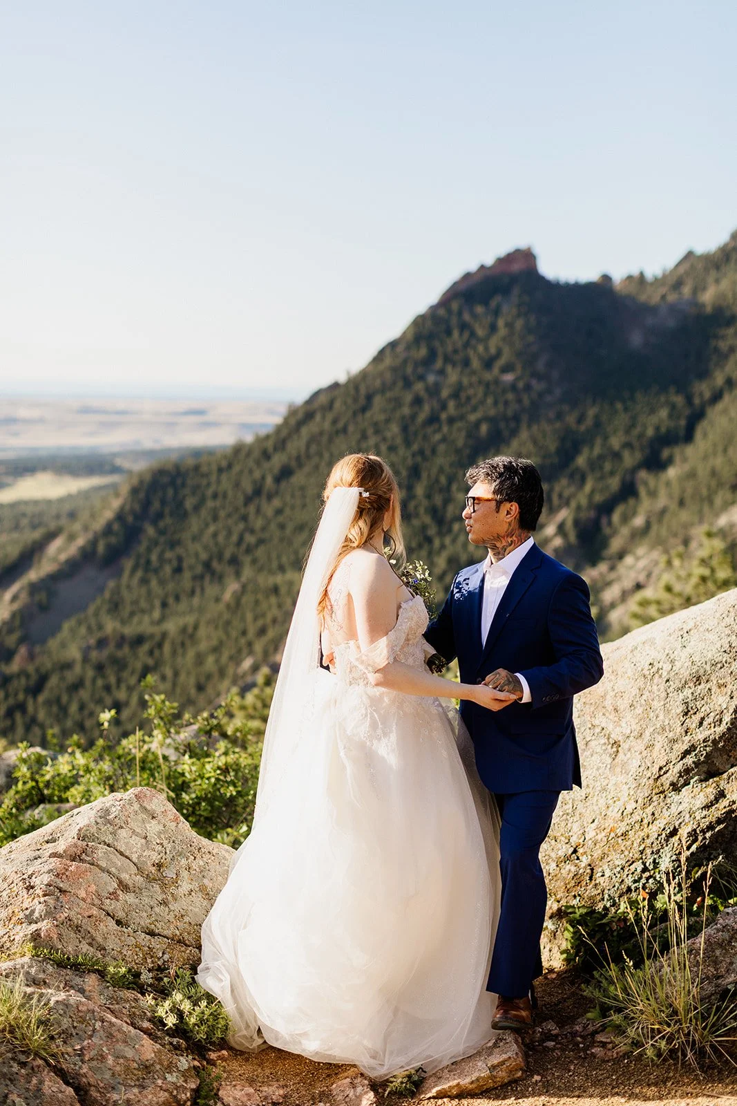 Couple holding hands on a rocky trail on Flagstaff Mountain above Boulder