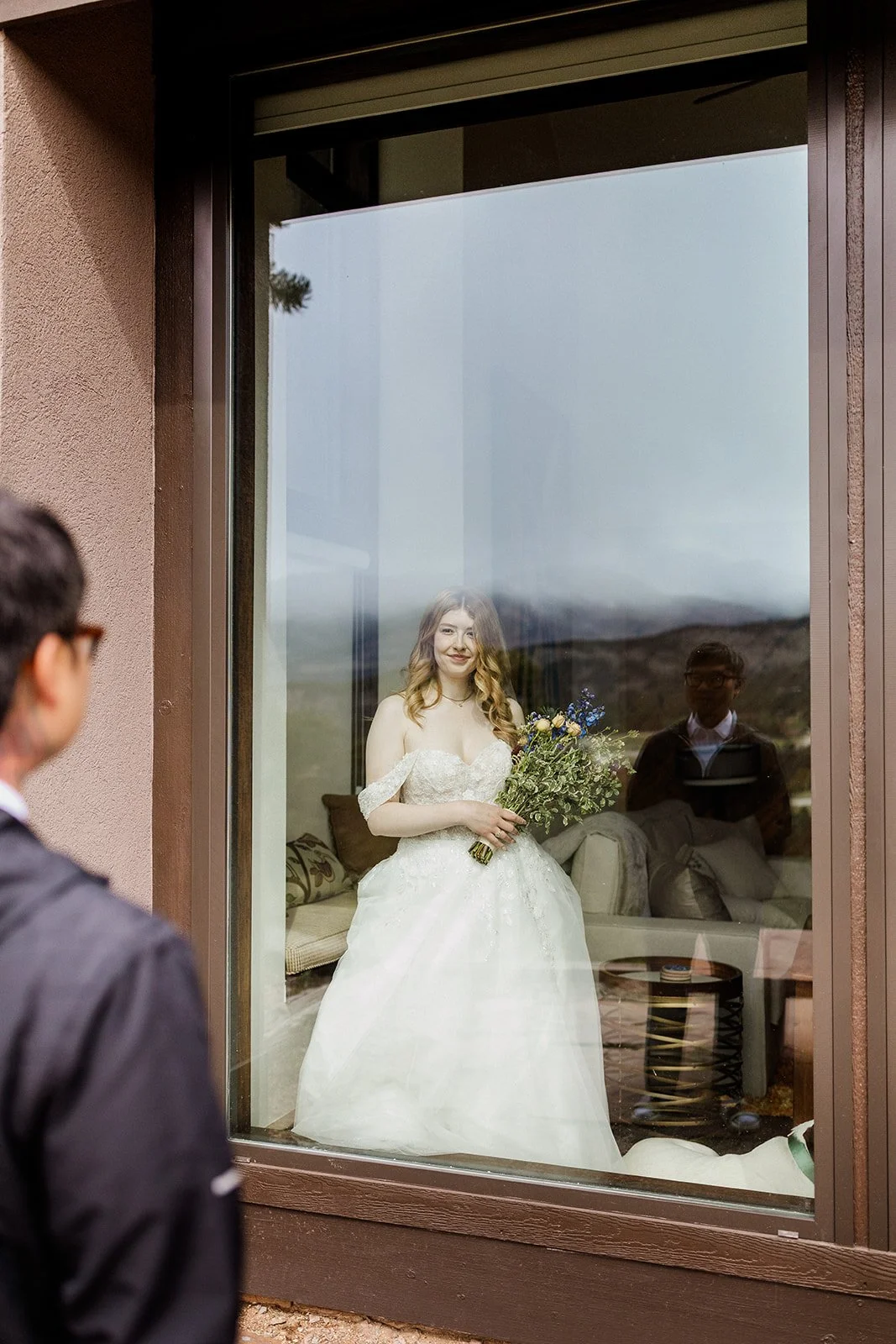 Groom looking at the bride through the cabin window