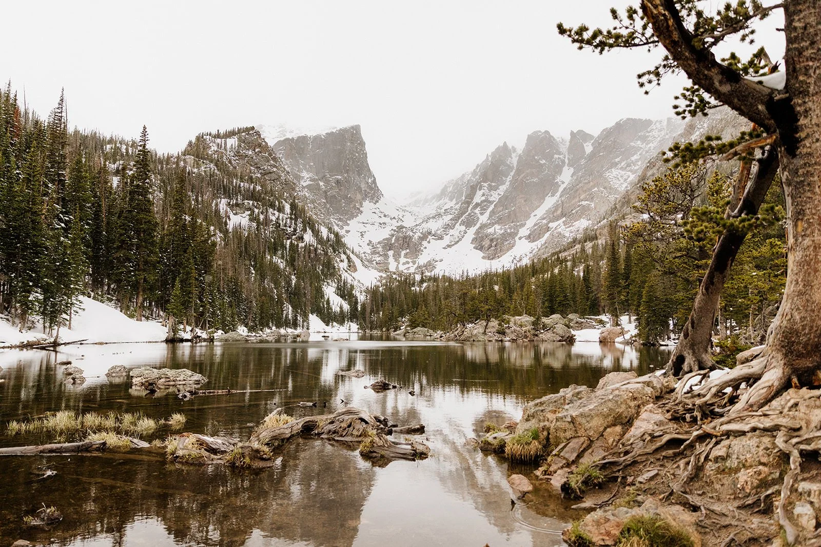 Dream Lake in Rocky Mountain National Park in late May with snow along the shore