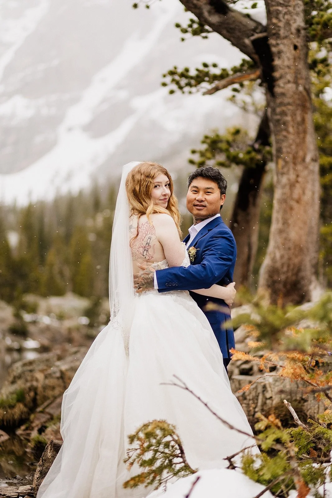 Couple hugging and smiling at the camera at Dream Lake
