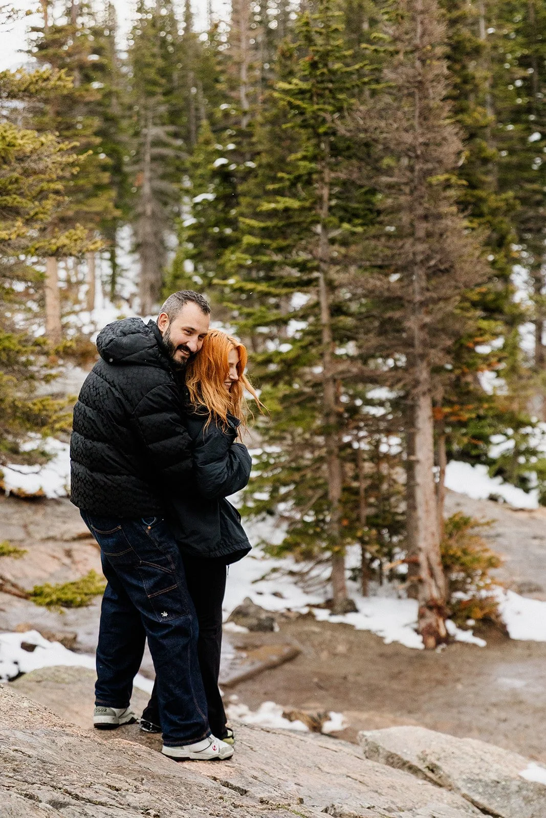 Friends hugging on the rocks at Dream Lake