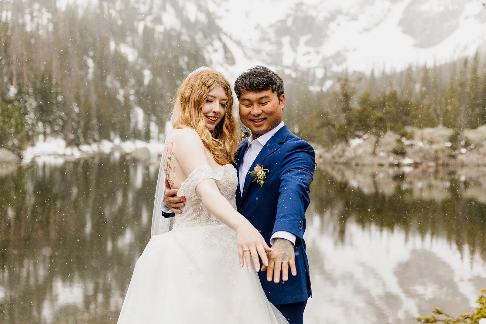 Couple showing off their wedding rings at Dream Lake