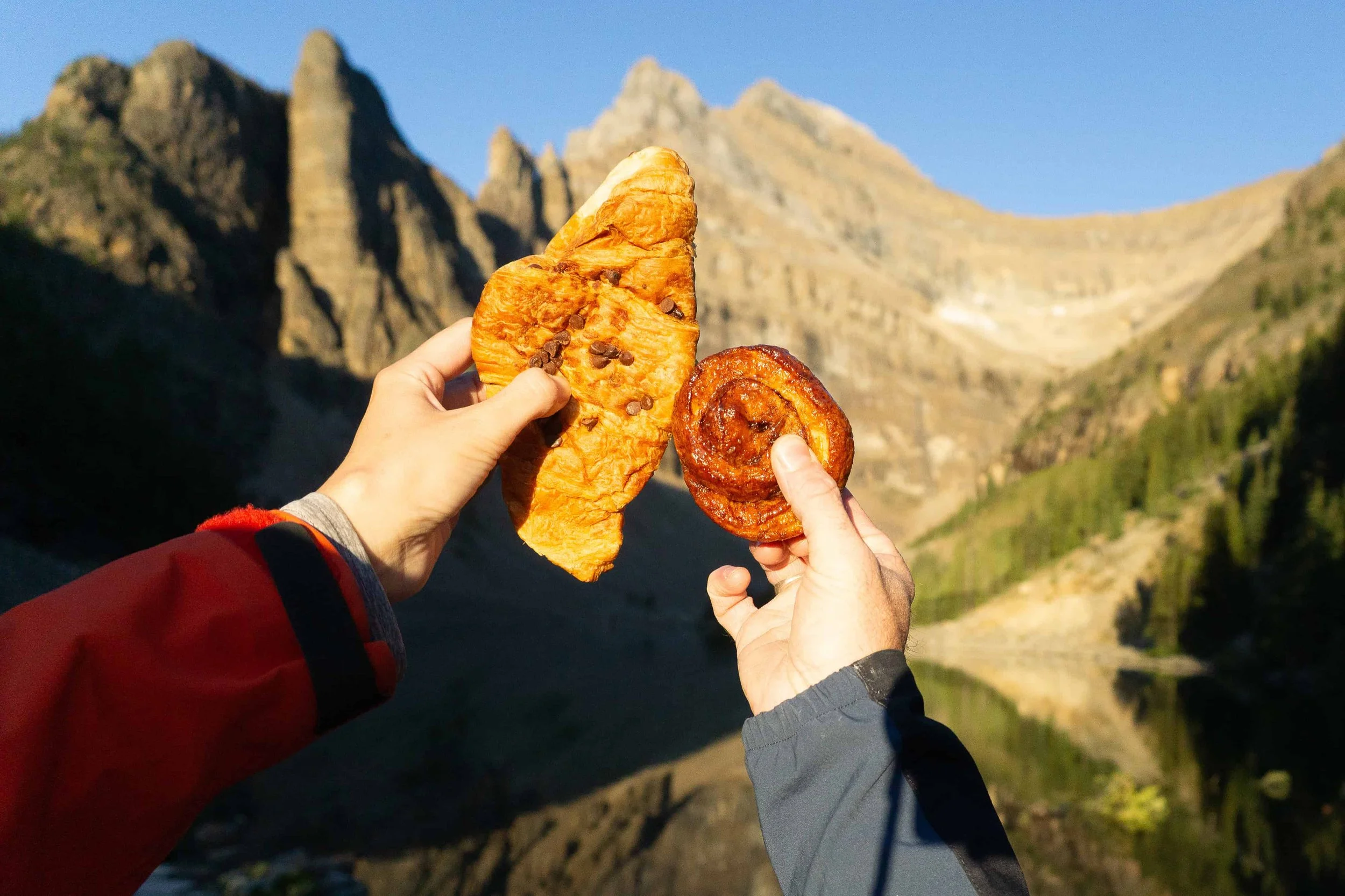 Eating pastries on a scenic Colorado trail between elopement locations