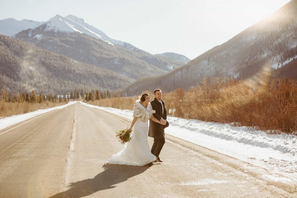 A couple on a snowy stretch of the Million Dollar Highway near Ouray, Colorado, in winter